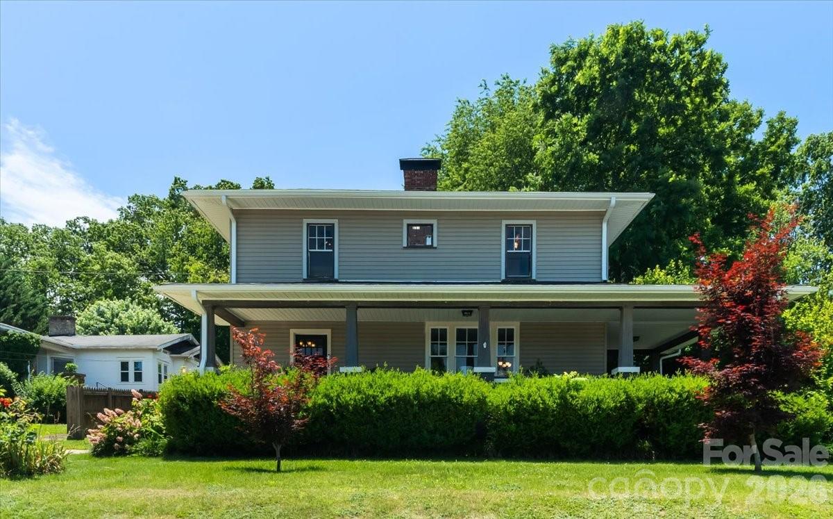 Perfect Blend of Historic 1920s Charm & Modern Luxury! 
Welcome home to this beautifully updated, 1,958 sq. ft. traditional cottage located in the heart of Canton. From the moment you arrive, you’ll be captivated by the classic wrap-around covered front porch—the ultimate spot to unwind and take in the stunning year-round mountain views. Inside, the main level features an inviting living room centered around a cozy fireplace, elegant French doors, and original hardwood flooring that radiates warmth throughout. The seamless flow leads into a separate dining space and a beautifully modernized kitchen, featuring granite countertops, sleek stainless steel appliances, and a highly functional laundry area right off the workspace.

Retreat upstairs to your private primary suite, complete with a beautifully tiled walk-in shower. Three additional spacious bedrooms and a second full bath on the upper level offer the ultimate flexibility for guest quarters, a home office, or creative spaces. Outside, enjoy a private, level backyard that is already fenced (just add a gate!) along with a detached garage and an interior-entry unfinished basement for extra storage. Enjoy quiet neighborhood living just minutes from downtown Canton and an easy 20-minute drive to Asheville!