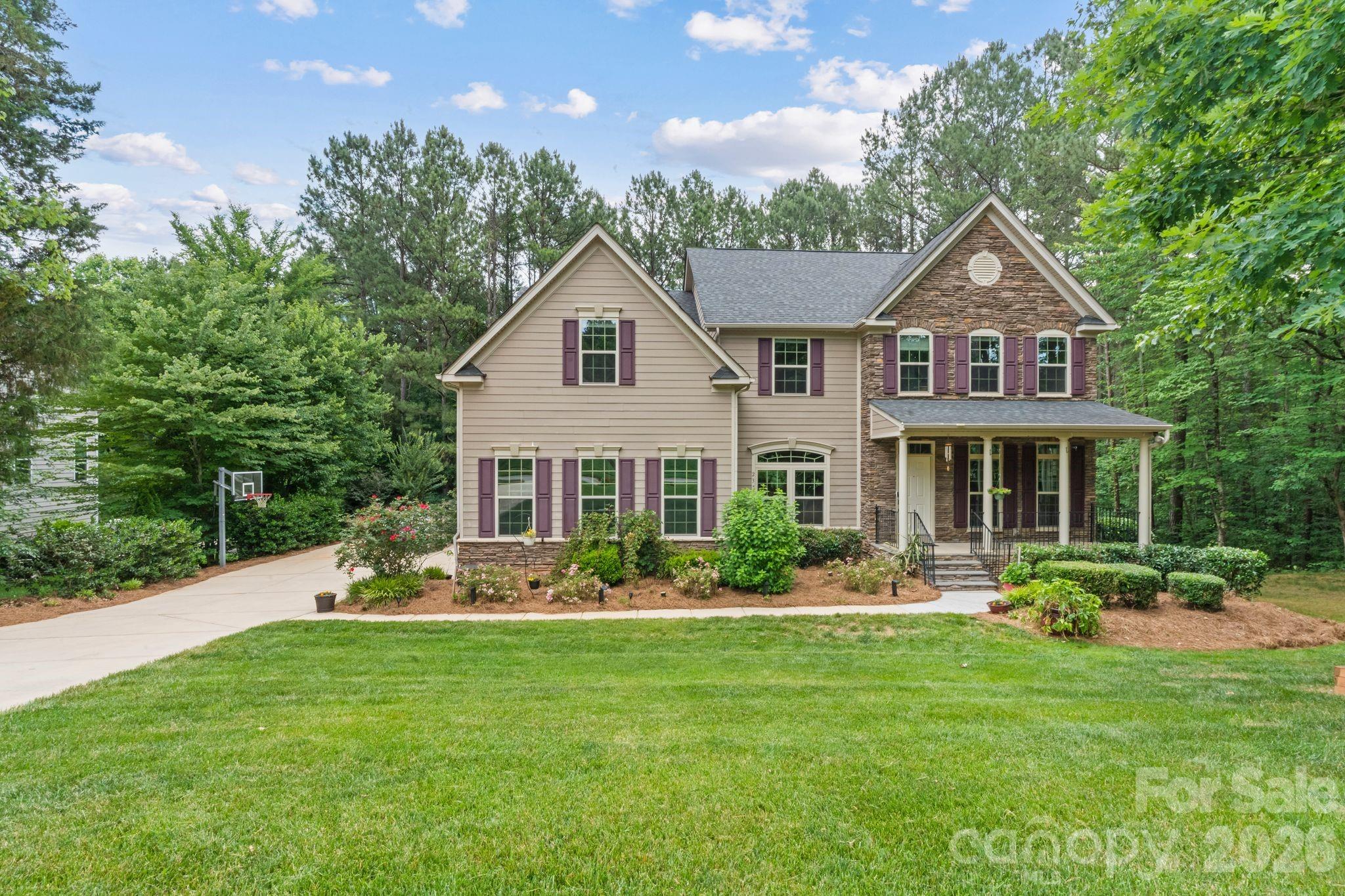 Welcome to 237 Ashmore Circle, where luxury, privacy, and convenience come together in one of Troutman's most desirable communities. Built in 2015 and thoughtfully updated with freshly refinished hardwood floors and fresh paint throughout, this meticulously maintained residence features 5 bedrooms, 5 bathrooms, and an impressive 5,269 square feet of living space. Located just minutes from Lake Norman, this home delivers the perfect balance of spacious luxury living and convenient access to the outdoor activities, dining, and entertainment that make the area so desirable. Located just minutes from multiple public and private boat launches, residents enjoy the perfect blend of adventure and everyday convenience. Spend your weekends boating, fishing, hiking at Lake Norman State Park just 6 minutes away, or enjoying a glass of wine at Davesté Vineyards less than 10 minutes from your doorstep. Downtown Troutman, with its growing collection of local restaurants, shops, and community events, is only 3 miles away. Tucked beside a wooded lot, the home enjoys a level of privacy that is difficult to find. Whether you're sipping your morning coffee on the front porch or unwinding on the back patio after a long day, you'll appreciate the peaceful setting and tranquil atmosphere that surrounds the property. Inside, the thoughtfully designed floor plan provides room for everyone. Hardwood floors flow throughout much of the main living area, while the spacious kitchen opens seamlessly to the breakfast nook and family room, creating the perfect space for everyday living and entertaining. Large windows across the rear of the home fill the space with natural light and provide beautiful views of the private backyard. The main level features a highly sought-after primary suite, providing convenience, privacy, and flexibility, along with a dedicated office or study perfect for working from home, managing a household, or creating a quiet retreat. Upstairs, you'll find four generously sized bedrooms, including an oversized bonus room with a closet that can easily function as an additional bedroom, media room, playroom, or flexible living space to suit your needs. Downstairs, you'll find an incredible 1,664-square-foot finished walkout basement that significantly expands the home's living and entertaining space. Complete with plumbing already in place for a future wet bar, the basement is ready to become the ultimate gathering space. An additional finished room creates the perfect opportunity for a home theater, game room, gym, or whatever best fits your lifestyle. A spacious 3-car garage further enhances the property's appeal, providing abundant space for vehicles, storage, and everyday convenience. With room for recreational equipment, workshop space, or additional storage, the garage delivers the versatility today's buyers appreciate while complementing the home's generous scale and functionality. Outside, the professionally maintained landscaping and pride of ownership are evident at every turn. Every detail of this home has been carefully cared for, creating a truly move-in-ready opportunity. The manicured grounds, mature landscaping, and peaceful surroundings further enhance the sense of privacy and tranquility that make this property so special. Residents of Falls Cove enjoy access to a community pool, clubhouse, and additional neighborhood amenities, all within a quiet and established setting. Simply put, there is not another active home currently available in the area that combines this level of square footage, privacy, location, and value. If you've been searching for a home with room to grow, exceptional privacy, outstanding community amenities, and the opportunity to enjoy the Lake Norman lifestyle without the Lake Norman price tag, 237 Ashmore Circle deserves a closer look.