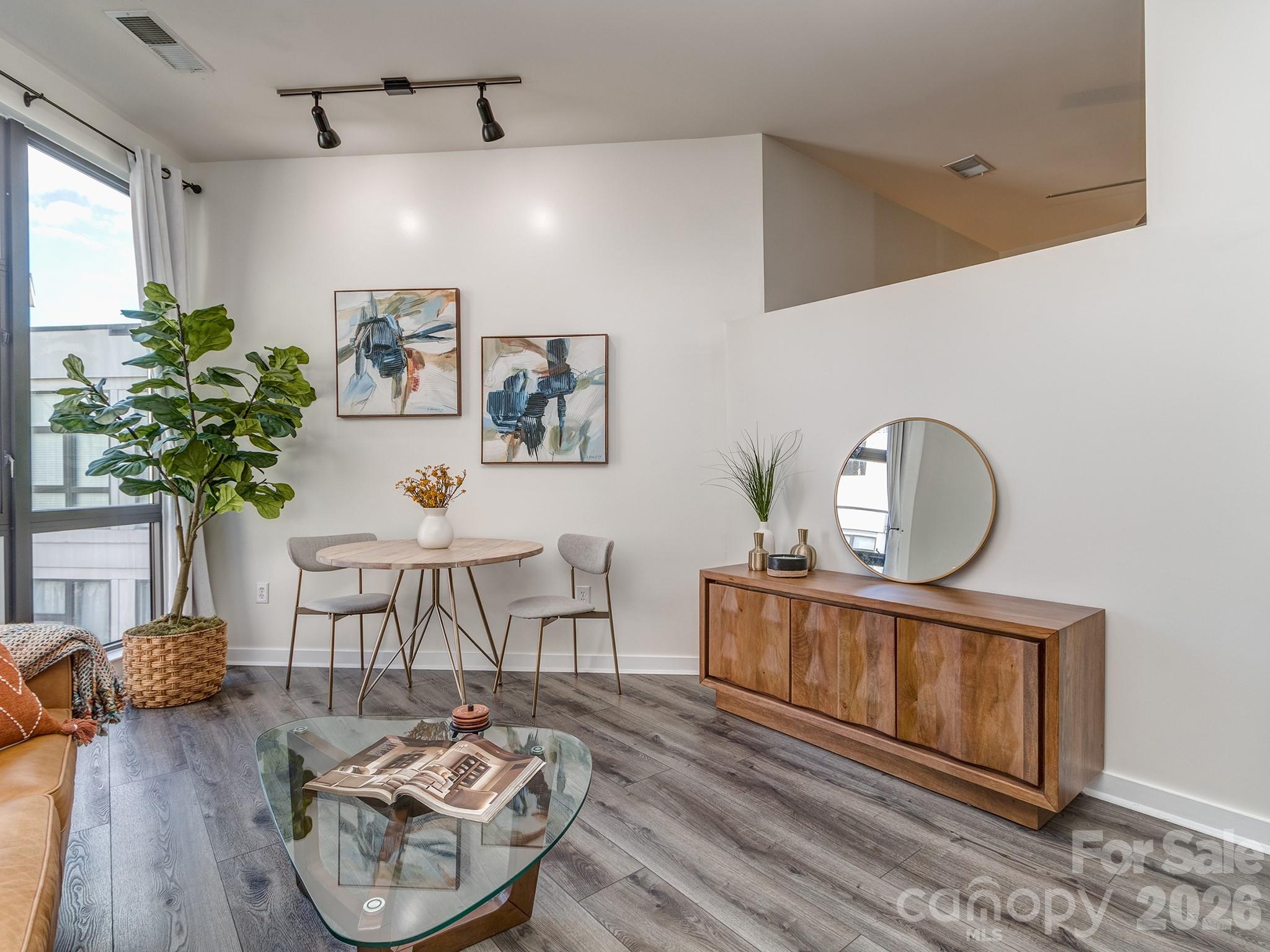 Uptown Studio with Smart, Low-Maintenance Living! This top-floor condo in the popular Court 6 community puts you right in the center of it all—just one block from the Spectrum Center and steps to dining, entertainment, and the light rail. Inside, you’ll find 10-ft ceilings, durable LVP flooring throughout, a built-in desk for work-from-home convenience, and a spacious walk-in closet. The kitchen and living area flow seamlessly, making the most of the studio layout, while the LG Wash Tower adds modern efficiency. Enjoy quiet courtyard views from your unit, along with the security of a gated garage and one assigned parking space. Perfect for those seeking convenient city living or an easy-care investment property!