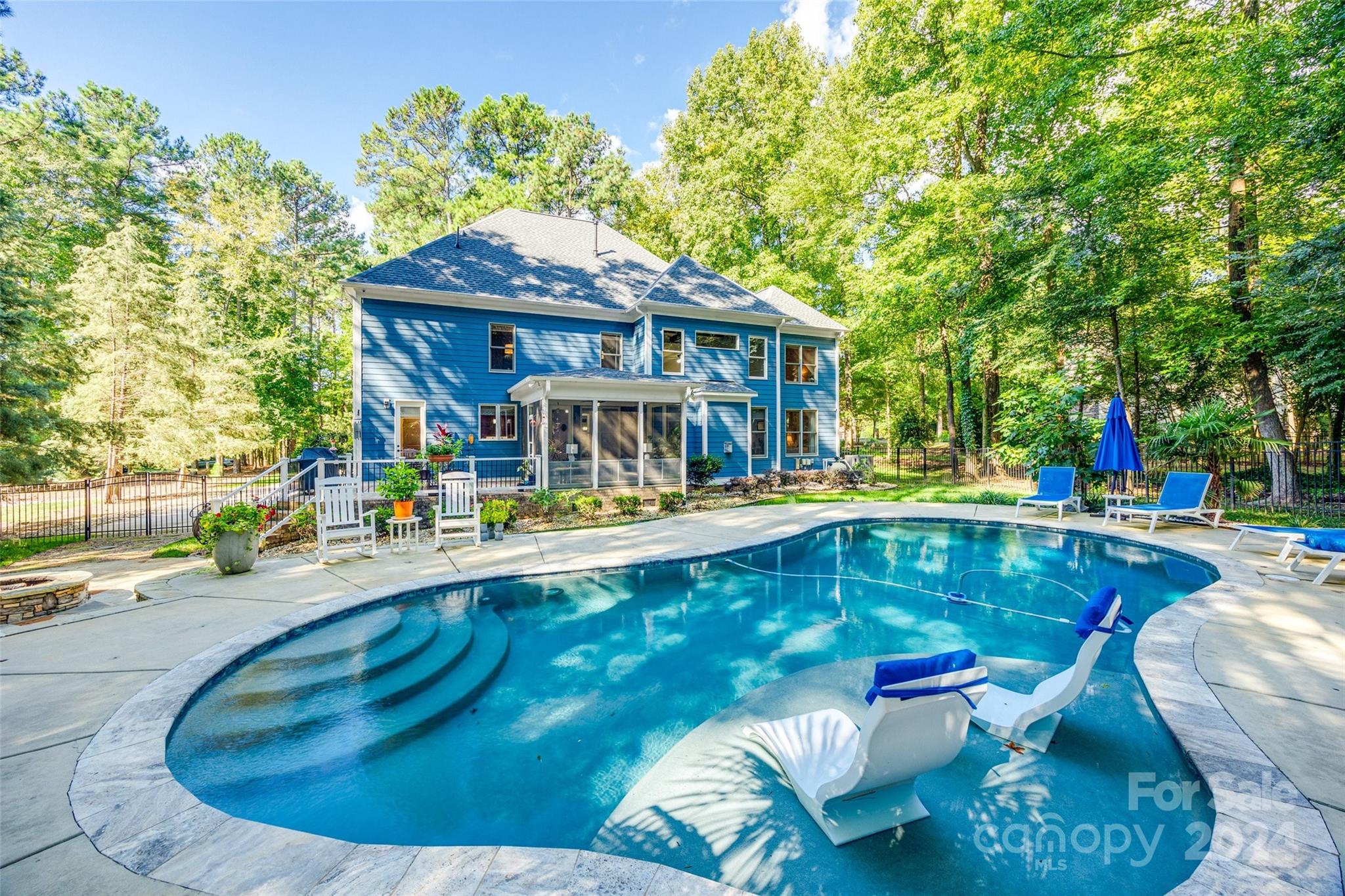 Wow, you do not want to miss this stunning home in Heron Cove! This 5bed/4bath home has it all. Guest suite on the main with full bath. Open concept, enjoy time with friends and family cooking in your oversized kitchen with brand new tile backsplash, or gather around the fireplace with your loved ones. Sip your morning coffee and watch the sun rise while sitting on your all-seasoned patio with sliding vinyl panels or sit around the fire pit and enjoy those Carolina evenings. Play in your salt water, Gunite pool 365 days a year as it's heated AND cooled. Sit on your rocking chair front porch and watch the sun set, enjoying those seasonal views of the lake. BRAND NEW ROOF. Garage has a workbench wired for power, racking system included. This community has walking trails, playground, boat storage, community pool and a kayak launch. Minutes from Charlotte, low SC taxes, and award-winning Clover Schools, this home is a must see!