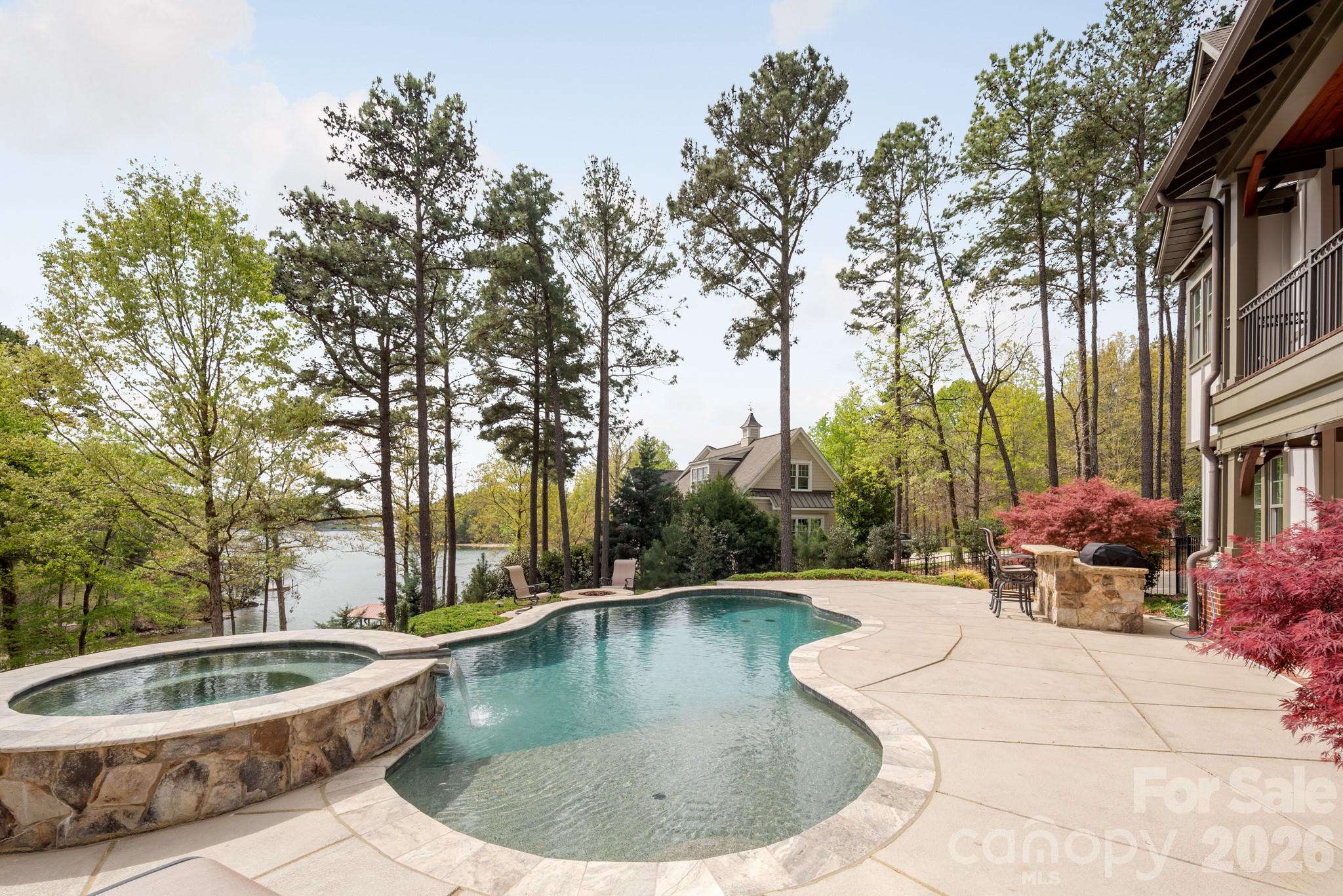 Experience exceptional waterfront living on the shores of Lake Wylie in this stunning 2016 Arts & Crafts-style home. Offering over 5,000 square feet of thoughtfully designed living space, this 4-bedroom, 4 full and 2 half bath residence blends timeless craftsmanship with modern luxury.

The main level features an open-concept layout anchored by a dramatic two-story living room with a soaring fireplace, creating a striking focal point filled with natural light. The chef’s kitchen is equipped with a gas cooktop, double ovens, and premium appliances, while the elegant dining area is perfect for entertaining. The primary suite on the main floor provides a private retreat with a spa-inspired bath, and a utility room plus additional half bath add everyday convenience.

Upstairs, you’ll find two generously sized bedrooms, each with access to full baths, along with a stunning loft-style office featuring beautiful wood ceilings, creating a warm and inspiring space perfect for working from home or relaxing with a view.

The fully finished walk-out basement is designed as a secondary living quarters, complete with a bedroom, full and half baths, full kitchen, living room, media room, and flexible space. With its private entrance, this level is ideal for guests, multi-generational living, or extended stays.

Outdoor living is equally impressive, featuring a resort-style in-ground pool with spa, hot tub, fire pit, and multiple covered and open-air spaces including a rear porch, deck, and patio—all overlooking serene water views. Enjoy direct lake access with a double-deck dock featuring a covered boat lift and two jet ski lifts on the lower level, plus a spacious upper-level entertaining area with breathtaking water views—perfect for relaxing or hosting on the lake.

Additional highlights include a 4-car garage (main level and basement), hardwood and tile flooring, insulated windows, security system, in-ground irrigation, fenced backyard, and beautifully wooded, hilly lot offering privacy and scenic surroundings.