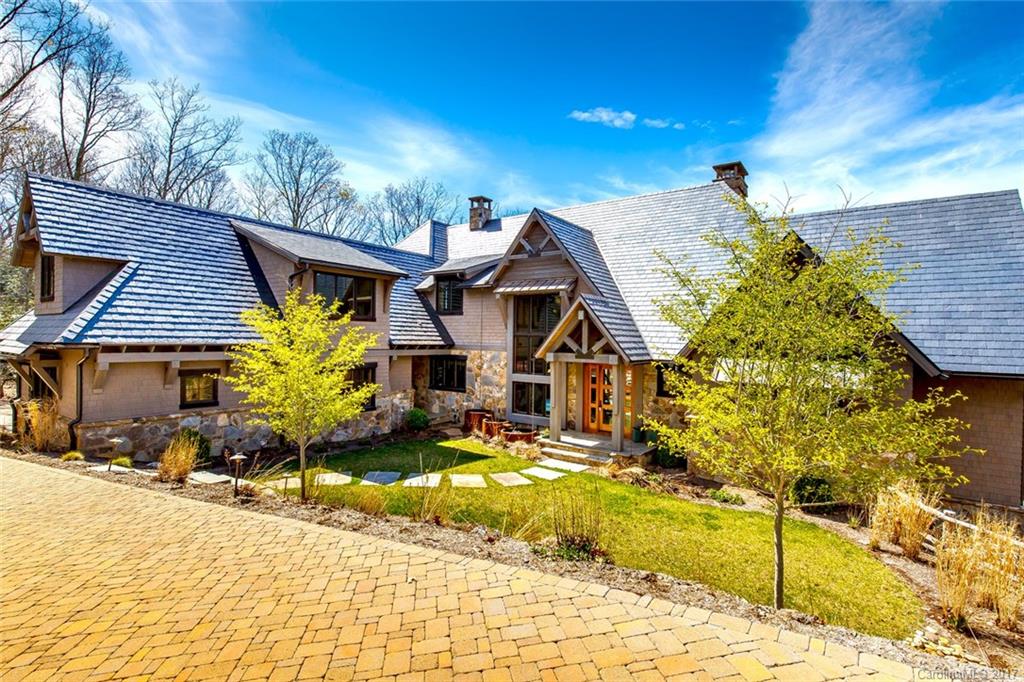 Amazing custom mountain modern home with incredible views in Walnut Cove. No detail has been overlooked with select walnut floors/doors throughout, wood and steel detailing, five fireplaces, fantastic master suite, stunning wet bar with wine closet, nearly 2,000 square feet of outdoor patios with fireplaces, theater room, workout room, awesome kid's bonus room with built-in bunks and lockers, and an elevator. Membership is available.