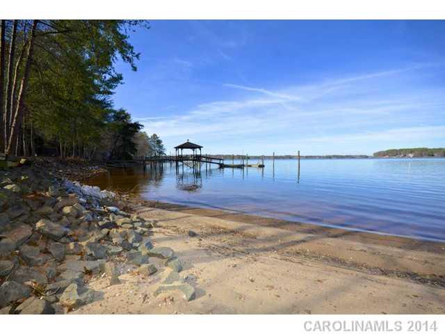 NO TRAFFIC-NO HOA-OPEN WATERVIEWS!  Private waterfront setting, your own sandy beach & rip rap on the shoreline. The flat building site is already permitted for a 4 BR septic and waiting for your custom dream home.  Existing pier with covered sitting area & concrete boat launch complete this waterfront paradise. If you are looking for beauty and privacy THIS IS IT!!! Building envelope has been staked by Surveyor.  Plans attached for 4300 sf 2 level home designed for this lot or design your own.