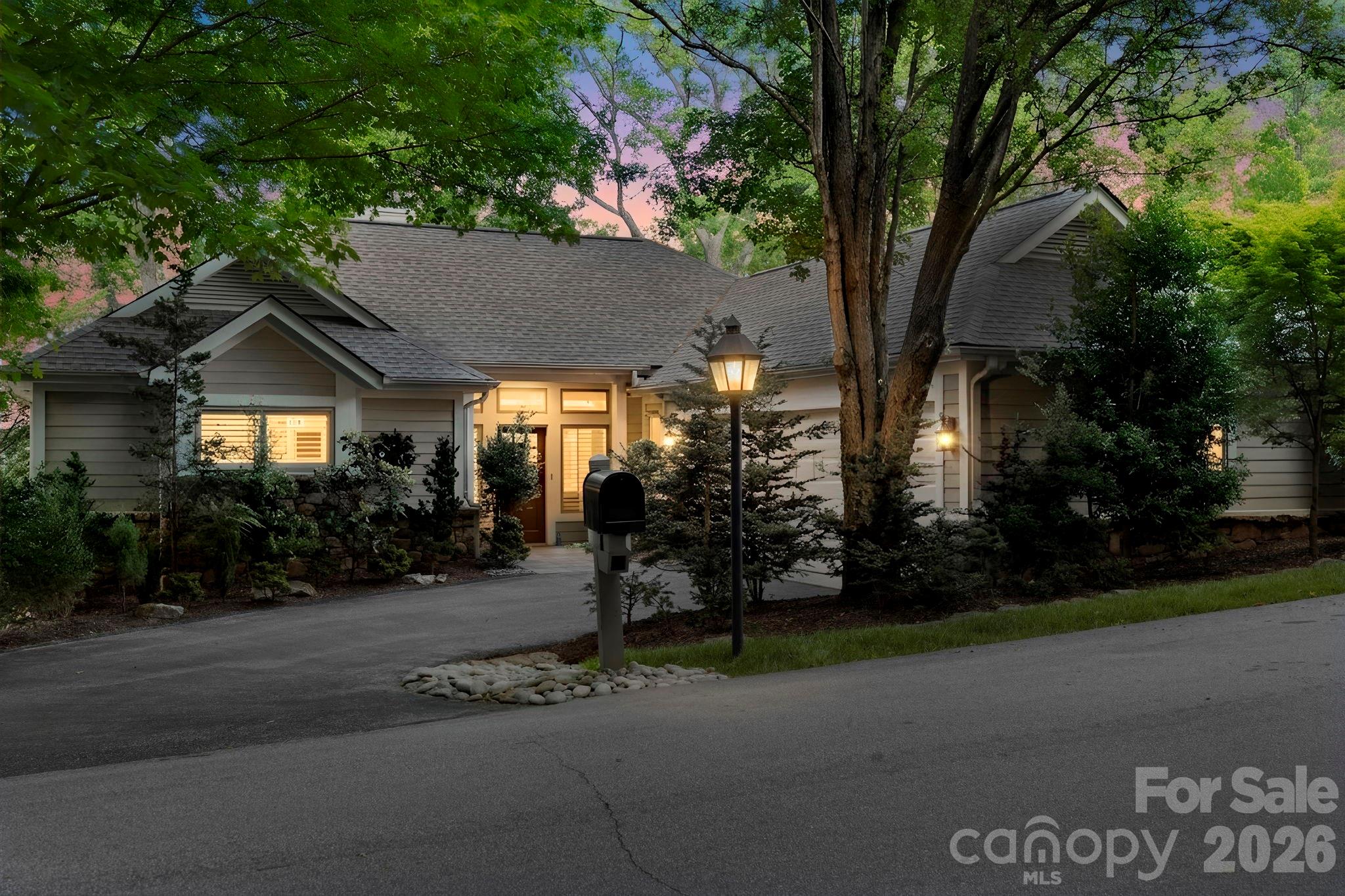 Set within Champion Hills, 8 Spring Ridge Lane offers a front-row seat to one of the area’s most established private communities. Positioned along a gentle ridge, the home takes full advantage of its northeastern exposure, with long-range mountain views that unfold gradually with the morning light.

The setting is just as compelling up close. Mature, thoughtfully designed landscaping surrounds the home, creating a natural sense of privacy while framing mountain views in nearly every direction. It’s the kind of setting that feels settled—nothing forced, nothing out of place.

Inside, the main living area is centered around those views, with large windows and an easy, open flow that keeps the landscape in focus. Granite countertops, hardwood floors, and well-executed custom closets speak to the quality of the home, while radiant heated floors in the bathrooms add a quiet level of everyday comfort. The layout is well balanced, with a main-level primary suite and inviting guest spaces below—comfortable for daily living and easy when hosting.

The connection to the outdoors is carried throughout. An upper back deck with a retractable sunshade offers a comfortable place to take in the mountain air, while the screened-in porch provides a quieter, more sheltered setting with the same long-range backdrop. Below, a private lower deck creates another vantage point, along with a tucked-away hot tub that feels completely removed—an easy place to end the day.

This home has been meticulously maintained, and it shows in the details. For those seeking a more immediate transition, there is also an opportunity to purchase the home fully furnished with a curated selection of high-end furnishings, including housewares and outdoor pieces, available separately.

Life in Champion Hills moves at its own pace. The Tom Fazio-designed course is a constant presence, along with a clubhouse that serves as a natural gathering place for dining and social events throughout the year. Fitness, tennis, pickleball, and walking trails are all part of the routine here, naturally woven into daily life.

Despite the setting, you’re only minutes from downtown Hendersonville, making it easy to step in and out of town as needed.

At 8 Spring Ridge Lane, the views, the setting, and the level of care throughout the home come together in a way that feels established and enduring—exactly what draws people to Champion Hills in the first place.
