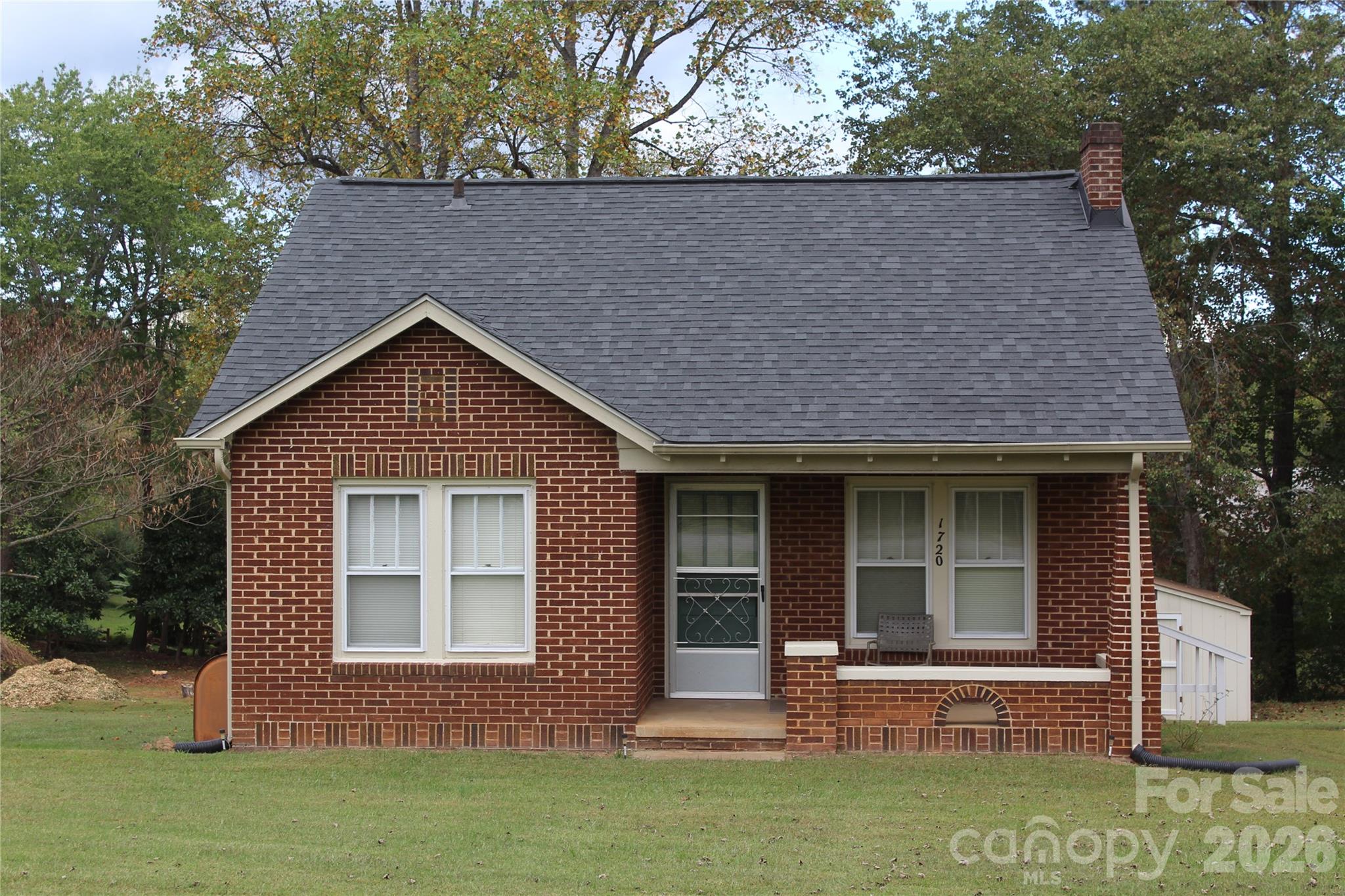 You will love living in this charming brick cottage-style home just outside the city limits of Drexel! This well-maintained home features two bedrooms and a bathroom with hardwood floors, except for the kitchen. on a half-acre corner lot!  New laminate flooring and interior painted throughout! Screened-in porch perfect for your morning coffee or enjoying the outdoors! An unfinished basement provides ample storage, and a 12x16 shed in the backyard holds all your lawn maintenance tools. A Shower in the basement, and a washing machine hookup so the washing machine could be moved to the basement.