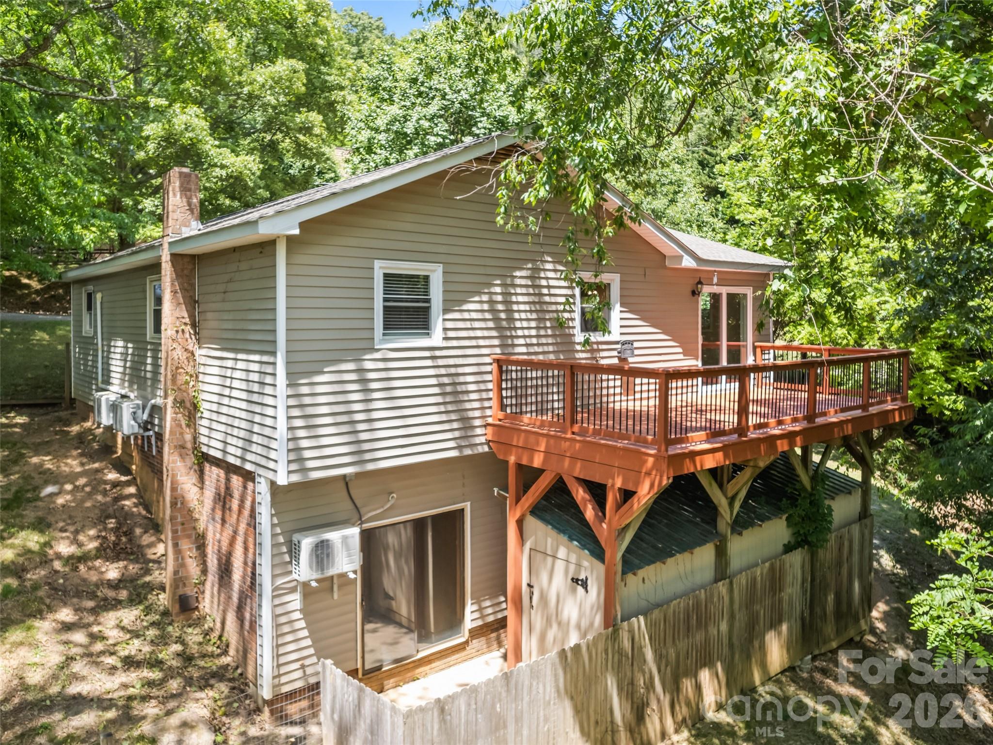 Searching for a home that feels manageable without sacrificing comfort? 157 Highland Terrace offers easy living in the Thompson Cove area of Clyde with a convenient location between Waynesville and Asheville. The covered front porch welcomes you home and provides a relaxing place to unwind. Inside, the spacious kitchen and adjoining dining area offer plenty of room for gathering, cooking, and everyday living. Step outside to enjoy the deck for grilling or entertaining, while the partially fenced yard gives space for pets or play. The drive-in basement adds valuable storage, workshop potential, or room for outdoor gear and hobbies. A practical home with comfortable spaces inside and out in a location that keeps you close to everything Western North Carolina has to offer.