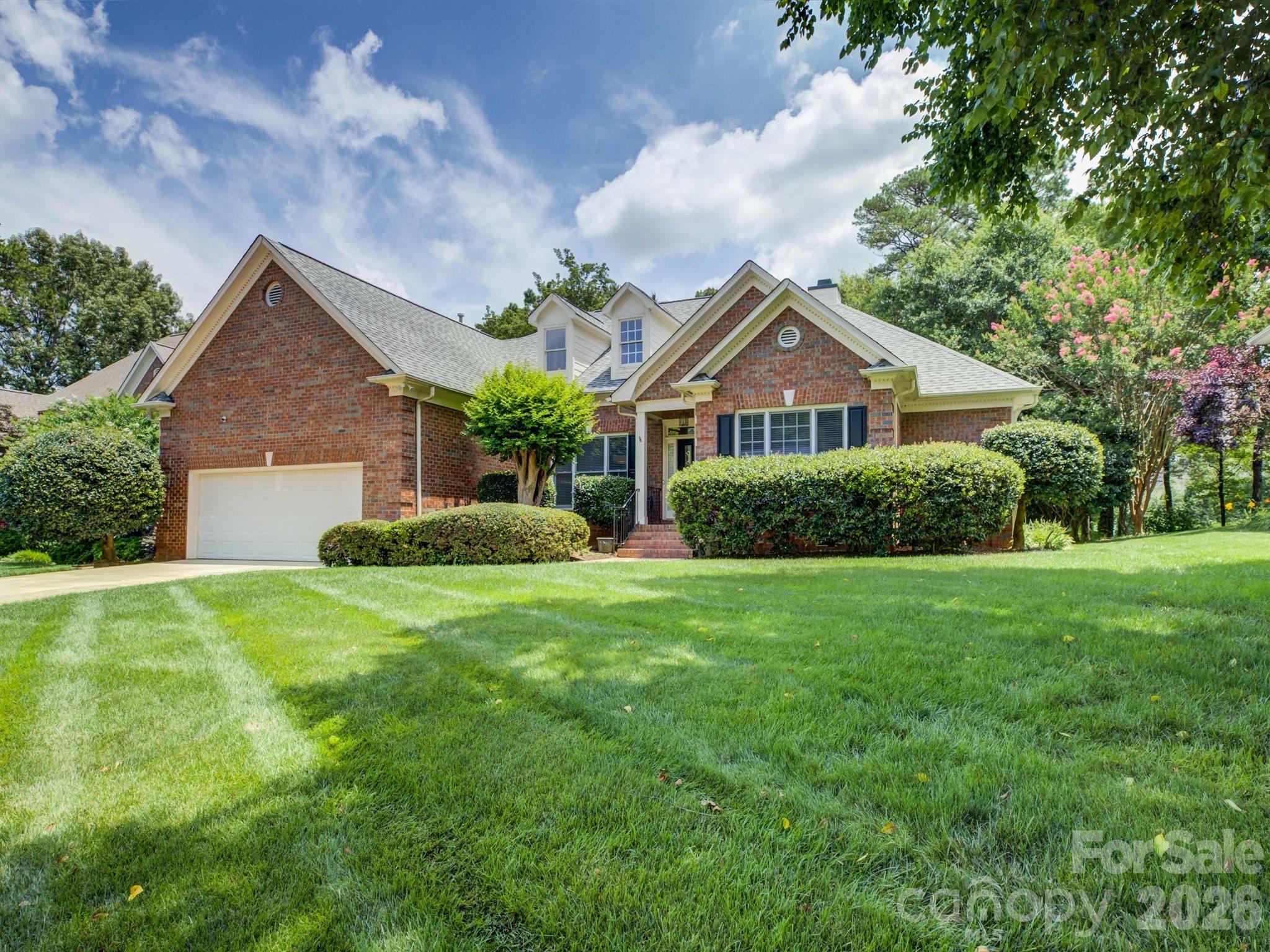 Nestled in the quiet Cobblestone neighborhood in Ballantyne, this beautiful 3-bedroom, 2.5-bathroom ranch serves as your own private oasis in the heart of Ballantyne. Delivering the ultimate lifestyle of convenience, you are located just minutes from the vibrant dining, shopping, and entertainment at The Bowl at Ballantyne and Blakeney, and less than two miles from Charlotte’s highly anticipated first Wegmans. Step inside to an airy, light-filled layout defined by soaring high ceilings and an ideal split-bedroom floor plan that maximizes privacy. The moment you step through the front door, you are greeted by a striking visual of the pond, framed perfectly by large windows in the welcoming living room. This central space features a cozy fireplace and vaulted ceilings, overlooking the back deck and offering a serene backdrop for daily living. A dedicated office space offers the perfect setup for remote work, while the formal dining room stands ready for hosting. The kitchen is designed for easy mornings and casual entertaining, complete with a convenient breakfast bar and a sunlit eat-in nook. Storage space is maximized throughout, anchored by a massive, attached two-car garage with plenty of extra room for gear, tools, or seasonal needs. The spacious owner’s suite is a true sanctuary, featuring a dual-sink vanity, a separate walk-in shower and soaking tub, and a generous custom-designed closet. Bedrooms two and three sit on the opposite side of the home and feature direct ensuite access to a shared full bathroom. The rear of the property transitions into a beautiful outdoor escape, featuring an expansive deck and patio that look directly over the calm waters of the community pond. Whether you are firing up the grill or relaxing by the water, this serene backdrop provides a peaceful escape from the daily hustle.