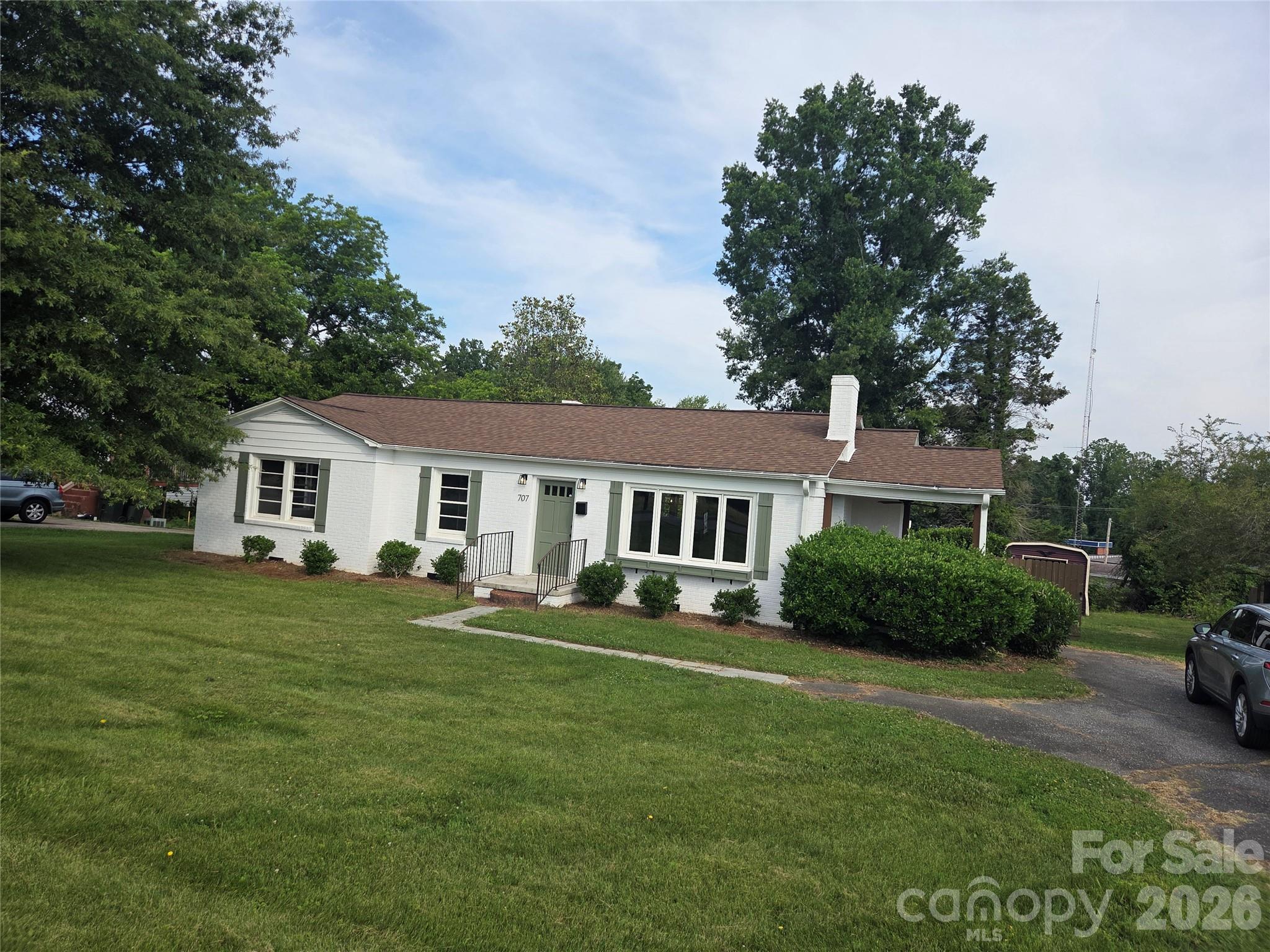Charming All-brick Ranch located in the heart of Cherryville with no HOA fees. $2500 Lender credit available with preferred lender. Welcome home to this beautifully updated 3-bedroom, 1.5 bath all brick ranch. This inviting property blends classic construction with modern upgrades, offering comfort, functionality and convenience. Step inside to discover beautiful hardwood floors that flow throughout most of the home, adding warmth and character. The open-concept layout seamlessly connects the living room and kitchen, creating a bright and welcoming space perfect for everyday living and entertaining. The upgraded kitchen is a standout feature, complete with granite countertops, new cabinetry, stainless steel appliances, and a double sink-designed with both style and practicality in mind. Relax on those summer evenings on the lovely side porch. An oversized shed on a level lot is perfect fit for all those outdoor lawn tools. Durable all-brick exterior for low maintenance. Fireplace is non operable. New HVAC in 2024. Conveniently located to all shopping, dining, medical and everyday amenities.