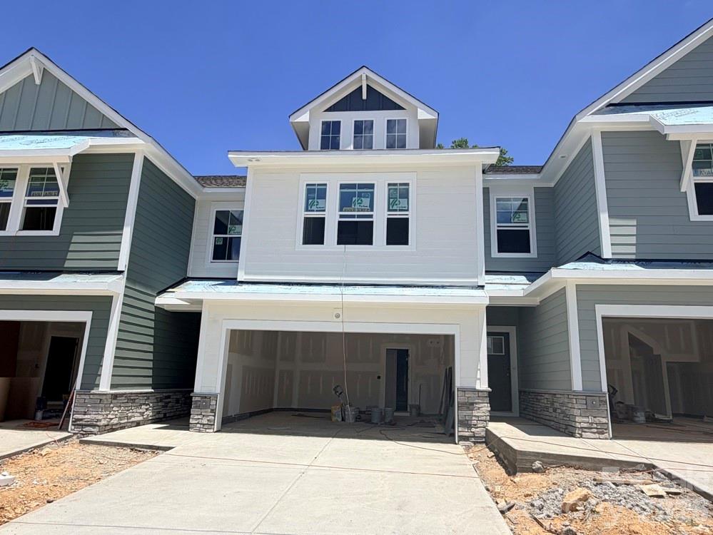 Discover the ease of low-maintenance living in this brand-new Thornhurst II townhome, just minutes from the charming shops, restaurants, and vibrant atmosphere of historic downtown Waxhaw! Embrace a lock-and-leave lifestyle with included lawn care, giving you more time to explore or relax in your private backyard. Spend weekends enjoying unique boutiques and local events, knowing your yard is maintained. Your backyard is a peaceful retreat with views of gorgeous trees and natural areas. This spacious home features an open, bright floor plan—perfect for entertaining or unwinding. The modern kitchen includes sleek quartz countertops and a large island overlooking your covered porch. After a long day, relax in the luxurious Owner's Retreat with an oversized walk-in closet. A side-by-side two-car garage and full driveway offer ample parking.