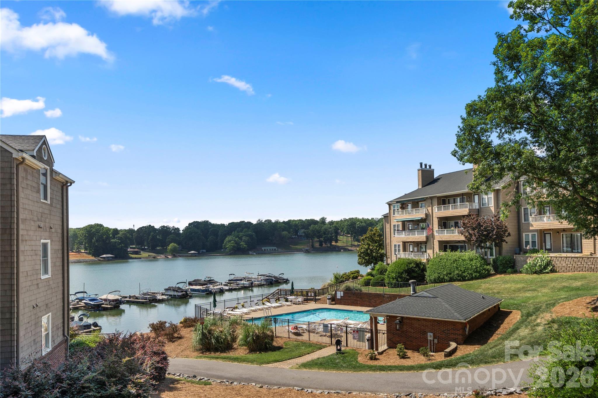 Beautiful waterfront condo in the Emerald Point community on Lake Wylie! This well-maintained end-unit offers stunning year-round water views and effortless one-level living. The open-concept layout features a spacious family room with a cozy wood-burning fireplace, a bright kitchen with breakfast bar, and a dining area perfect for entertaining. The primary suite includes a walk-in closet and relaxing garden tub, while the secondary bedroom and full bath provide ideal space for guests or a home office. Enjoy peaceful mornings and evening sunsets from the patio overlooking the water. Community lake amenities include boat slips, paddlesport launch site, outdoor pool, sidewalks, and street lights. Conveniently located near shopping, dining, the outlet mall, airport, and major commuter routes while still offering a private lakefront retreat feel. Assigned parking included. An incredible bonus—this unit includes access to a leased boat slip making it easy to enjoy days out on the water! Rare opportunity for waterfront living in Charlotte at an exceptional value!