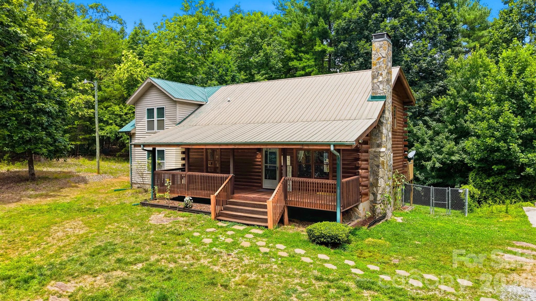 Back on the market, no fault of seller! Tucked away in the scenic foothills, located in the sought after Dudley Shoals area, this beautifully maintained log home on almost 7 acres offers rustic charm and room to grow. Wake up to serene mornings on your rocking chair front porch sipping coffee as birdsong and gentle breezes welcome the day with natures beauty unfolding right before you. Inside, you’ll find a spacious, functional layout with an inviting main living area that flows seamlessly into the kitchen and dining space, ideal for both everyday living and entertaining. The kitchen has been updated with new stainless steel appliances, offering a clean, modern contrast to the warmth of the natural wood interior, plenty of storage and a breakfast bar that provides additional seating. Enjoy winter evenings gathered around the rustic stone fireplace with the new wood stove insert (Regency) in the living room. Upstairs offers a large family room, full bathroom and two additional bedrooms with a 4th room currently being used as a home gym. Primary suite on main level with his and hers walk-in closets, a large garden tub, tiled walk-in shower, and dual vanities. Step out back on the large deck to enjoy the fenced-in backyard, perfect for pets, play, or simply relaxing in your own private outdoor space. The logs were professionally refinished in 2022 providing long term durability. Surrounded by the natural beauty of Western North Carolina, this property offers the peace and privacy buyers are looking for while still being conveniently located to Lenoir, Hickory, and the High Country. This home is full of character—and one you don’t want to miss.