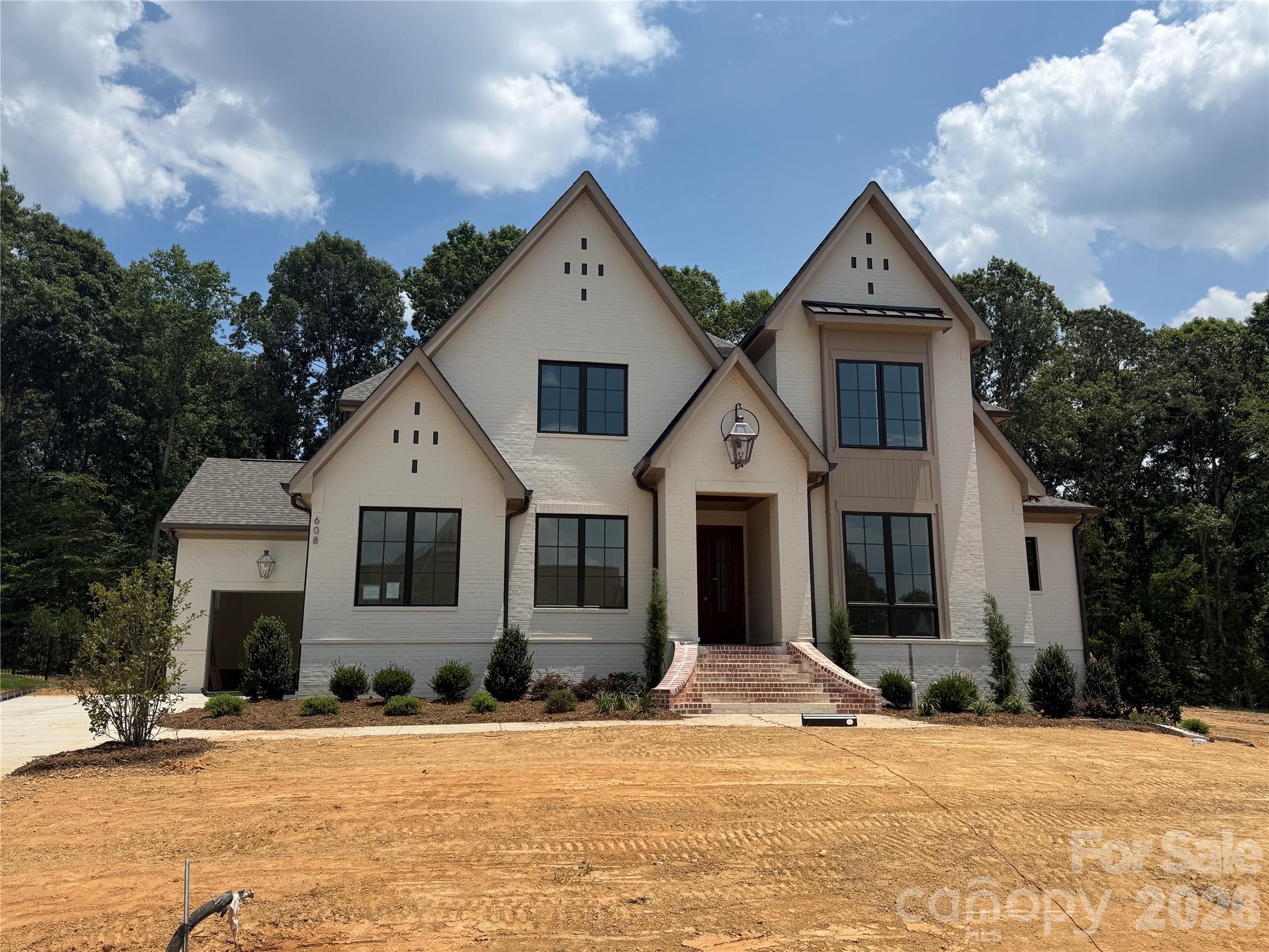 Brand new custom home opportunity in Twin Lakes on a premium lot! This Linnane home will be ready before the end of August! Secure a brand new custom home without the 12 month wait. The Mannington plan features a main-level Primary Suite and a main level Guest Suite, Kitchen with huge island open to the Family Room, dramatic 2-story Foyer with extensive trim package all the way to the ceiling! An oversized upstairs Rec Room, and expansive walk-in finished storage. Beautiful rear covered terrace that leads to a large pool-ready homesite offering endless outdoor possibilities. This is very well appointed home with a Thermador appliance package, white oak floors and staircase, brass strapped kitchen range hood, and an extensive interior trim package. Enjoy resort-style amenities: scenic trails, waterfront gazebo, championship pickleball, and community dock for kayaking, canoeing, and paddle boarding. Rare opportunity for a brand new home that is almost completed in Twin Lakes—this one won’t last! Interior and Exterior painting ongoing. Additional photos will be uploaded as construction completion continues to progress. Metal railings will be installed on the raised terrace as well as the front entry steps. Additional, stone will be installed at the front entry and on the raised terrace floors.