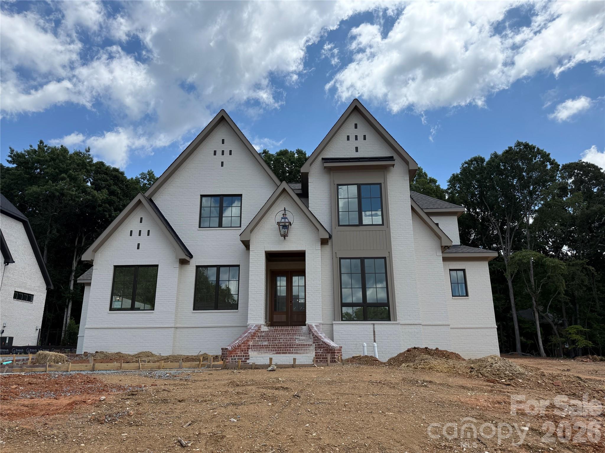 Brand new custom home opportunity in Twin Lakes on a premium lot! This Linnane home will be ready before the end of September! Secure a brand new custom home without the 12 month wait. The Mannington plan features a main-level Primary Suite and a main level Guest Suite, Kitchen with huge island open to the Family Room, dramatic 2-story Foyer with extensive trim package all the way to the ceiling! An oversized upstairs Rec Room, and expansive walk-in storage. Beautiful rear covered terrace that leads to a large pool-ready homesite offering endless outdoor possibilities. This is very well appointed home with a Thermador appliance package, white oak floors, brass strapped kitchen range hood, and an extensive interior trim package. Full design portfolio interior and exterior finish package available to view. Enjoy resort-style amenities: scenic trails, waterfront gazebo, championship pickleball, and community dock for kayaking, canoeing, and paddle boarding. Rare opportunity for a brand new home that is almost completed in Twin Lakes—this one won’t last! Interior and Exterior painting ongoing. Additional photos will be uploaded as construction completion continues to progress.