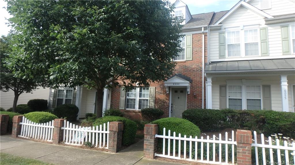 Bright open townhouse with laminate wood floors throughout main level. Large eat in kitchen with center island has views of formal dining room and living room. Master suite has tray ceiling, walk in closet and private bath. Spacious secondary bedroom. Deck off back with storage building and 1 car parking pad.