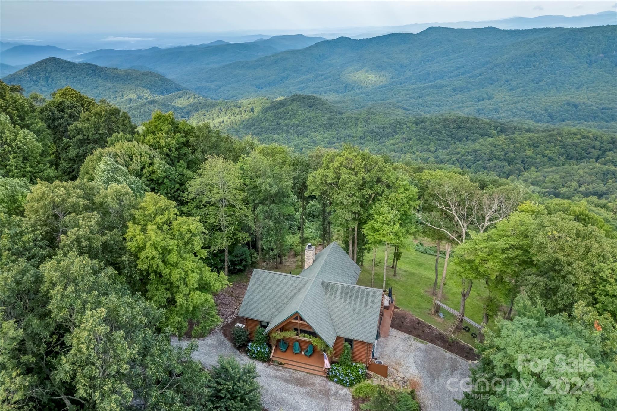 Welcome to Cross Cabin, an enchanting log home near the top of Sassafras Mountain, the highest in South Carolina. This home offers stunning long-range views into three states.Located in Pinnacle Point Mountain, this gated luxury enclave is known for its mature forests, cool summer temperatures, and privacy. Cross Cabin is a perfect retreat from urban life, yet close to essential amenities—just 20 minutes from Brevard, NC, and an hour from both Greenville and Asheville. This log home, crafted by a career homebuilder, features over 2,800 heated square feet, three spacious bedroom suites, and ample room for guests. Modern conveniences include fiber internet and a tankless water heater. The grand stone fireplace and 19-window wall fill the home with natural light. The fully equipped kitchen is ideal for entertaining.With approximately 1,400 square feet of deck space, Cross Cabin seamlessly integrates indoor and outdoor living. Discover one of the highest-elevation homes in South Carolina.