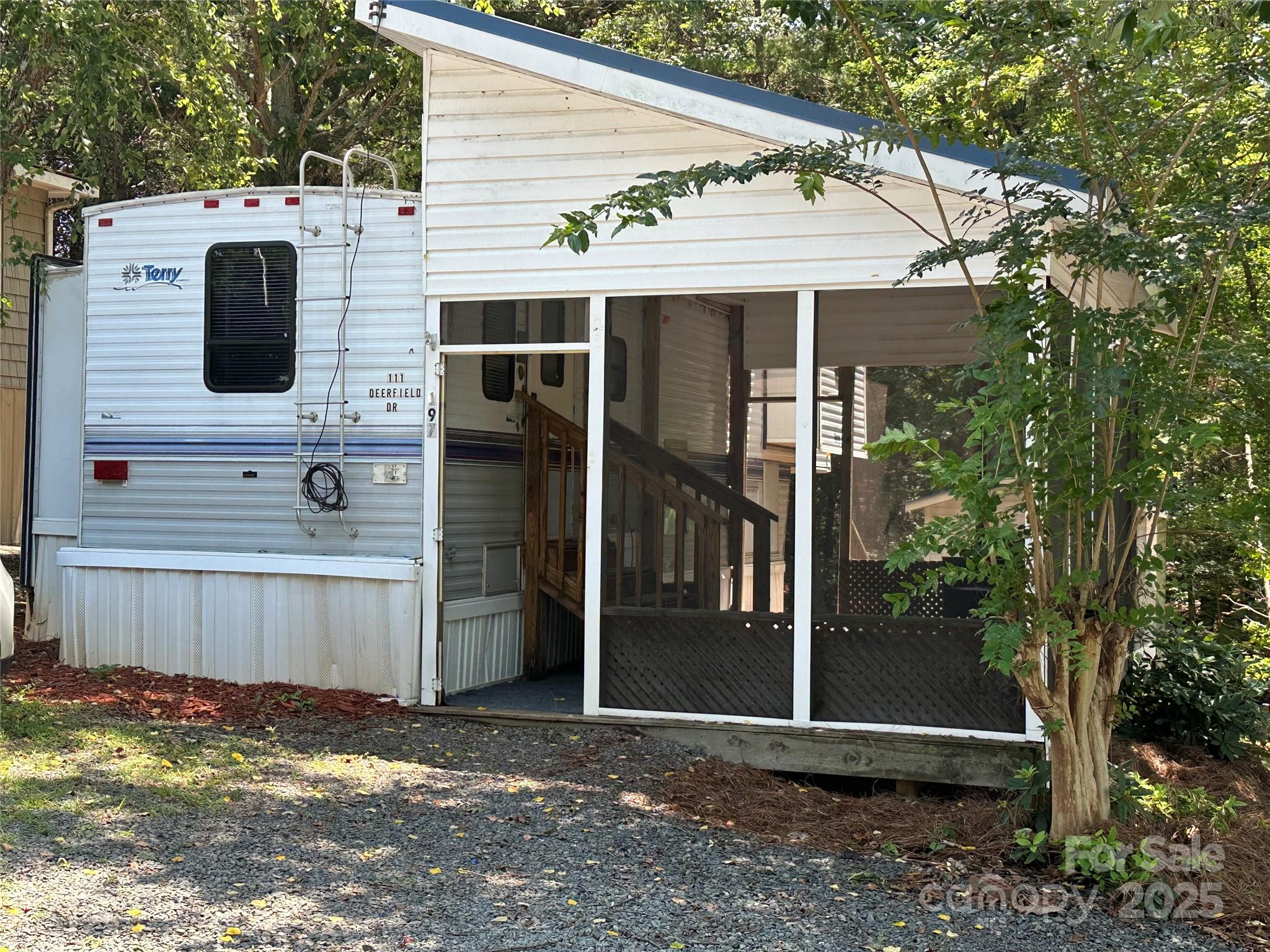 Don’t miss this fantastic opportunity to own a 5th wheel camper on a deeded lot complete with a screened porch. This retreat features modern paint tones, newer flooring, and is ideal as a weekend escape or starter lake property. Tucked away on a cul-de-sac street and backing up to a wooded area, you'll appreciate the added privacy. Property is sold AS IS and power has been turned off at property. Located in the gated waterfront community of Badin Shores Resort on Badin Lake, you'll enjoy full access to resort amenities including a swimming pool, putt-putt, basketball courts, sandy beach with lake swim area, fishing pier, waterfront boardwalk, and more. Whether you’re looking for a relaxing retreat or fun-filled weekends, this can be your place to start lake life!