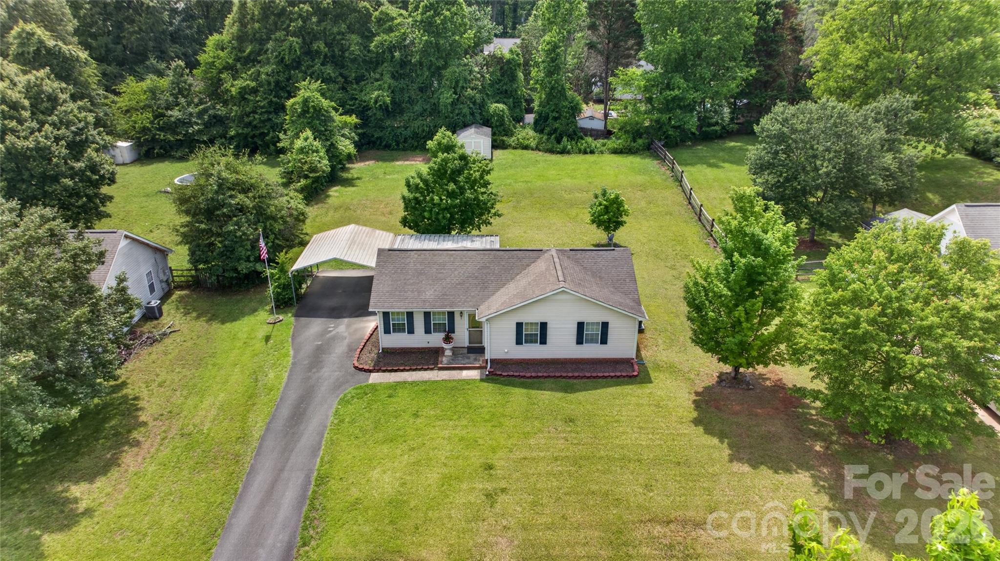 Near Historic WAXHAW... Approximately Half-Acre (.459)! Highly Desirable One-Level Ranch Floorplan With NO STEPS!!! No HOA... 3 Bedrooms, 2 Full Baths... This Quiet, Peaceful Setting Retains All the Conveniences Of Nearby Grocery, Pharmacy, Medical, Dining, & More! Also Less Than 2 Miles To Charming Downtown Waxhaw With Numerous Shops, Restaurants, Popular Festivals and Events Throughout the Year.  Enjoy the New (2026) Flooring Update With Low Maintenance Plank-Style Flooring Throughout Living Areas and All Bedrooms. Durable, Ceramic Tile Flooring in Bathrooms with Custom Vanities. Truly MOVE-IN READY WITH ALL APPLIANCES INCLUDED... Stainless Refrigerator, Stainless Dishwasher, Stainless Electric Range/Oven, Stainless Microwave... and Washer/Dryer Set Conveys!!! Step onto the Covered Back Patio to Enjoy Quiet Mornings... Relaxed Evenings... Or Effortless Entertaining While Overlooking the Serene Backyard Setting. At Rear of Property is an Outbuilding for Additional Storage Convenience. With Generous Outdoor Acreage... Freedom From HOA Restrictions... and One-Level Living... This Home Delivers Highly Desirable Privacy While Convenient to Everything... A Rare Find!!!