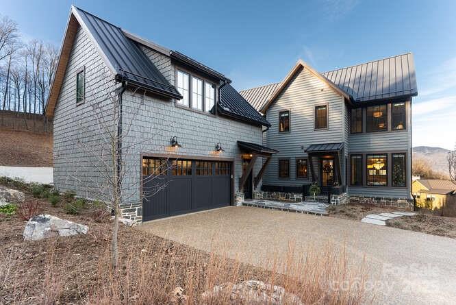 Effortless Mountain Living

Set within the private gates of Balsam Mountain Preserve, this refined mountain residence is prepared for immediate enjoyment, pairing timeless architecture with a thoughtfully low-maintenance lifestyle. Completed less than one year ago, this offering represents the first resale in the Village and the largest of the Village home models, The Willow—an uncommon opportunity combining scale, design, and ease within this sought-after enclave.

The interiors embody modern designer Appalachian luxury, expressed through a rich, nature-inspired palette and carefully curated finishes. Wide-plank engineered oak hardwood floors anchor the home, while expansive windows frame mountain views and introduce an abundance of natural light. Five well-appointed bedrooms, each with a private en-suite marble bath, provide comfort and privacy for both everyday living and hosting.

The kitchen is elegantly composed, centered around a marble island and custom cabinetry designed for both beauty and discretion. Premium appliances include a Wolf induction range, Sub-Zero refrigeration, Cove dishwasher, Marvel wine refrigerator, and Whirlpool laundry. A concealed pantry supports uncluttered living, while bespoke Roman shades, tailored drapery, designer lighting, curated wall coverings, and refined textiles create a cohesive interior experience throughout.

Living areas are grounded by a gas stone fireplace with custom built-ins, offering warmth and architectural presence. The primary suite serves as a private retreat, featuring heated marble floors, a steam shower in the primary bath, custom glass enclosures, and expansive custom-designed closets. All bathrooms are finished in marble with designer tilework and glass enclosures, reinforcing a sense of understated luxury.

Outdoor living unfolds across a generous mountain-facing deck, thoughtfully appointed for year-round enjoyment and enhanced by an outdoor kitchen with grill, rotisserie, and pizza oven. Infrared heaters extend seasonal use, while a fenced front courtyard provides a discreet and practical space for pets.

A rare feature within the Village, the detached two-car garage includes epoxy flooring, dual high-capacity his-and-hers electric vehicle chargers, and a substantial studio above with kitchenette and full bath—well suited for guests, extended family, or a private workspace. Additional considerations include a whole-house generator, expanded propane capacity, encapsulated crawl space with climate-controlled storage, integrated CAT6 wiring, fiber connectivity to the property, a fully integrated whole-house network, plumbing in place for an upstairs laundry, and custom built-ins throughout.

This residence offers a composed balance of design, comfort, and effortless ownership within one of Western North Carolina’s most distinguished private communities.