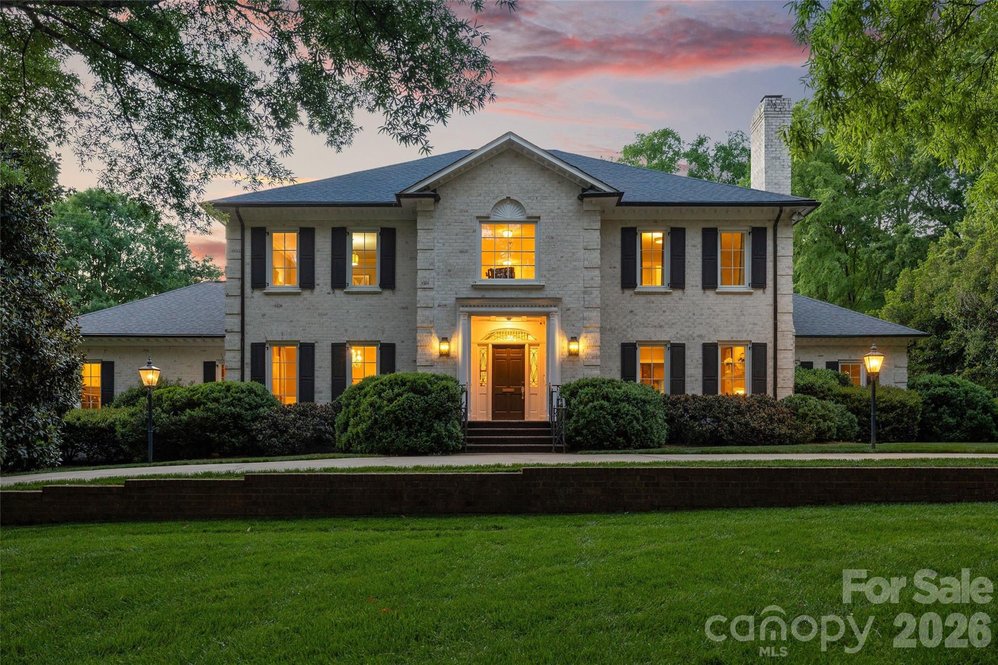 Nestled on a beautifully level, .72-acre homesite in one of Charlotte's most coveted neighborhoods, this exceptional full-brick residence offers an effortless blend of timeless elegance and modern luxury. Boasting 5 bedrooms, 5 full baths, and 2 half baths, the home is thoughtfully designed for both grand-scale entertaining and comfortable everyday living. This property is a true outdoor oasis featuring a fully enclosed backyard and lush landscaping for unparalleled privacy. Enjoy a covered back terrace and lower-level patio with outdoor kitchen, play area, and gardens! A very rare opportunity with endless expansion potential on one of the finest lots and locations in the neighborhood - a compelling offering not to be missed.