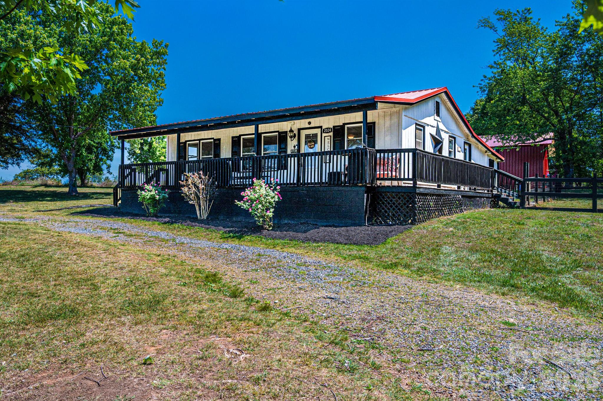 Charming farmhouse full of character and country vibes just listed in Vale NC!  This adorable 2-bedroom, 1-bath home offers just under 1,000+/- square feet with a warm and inviting farmhouse-style interior (Magnolia anyone?) featuring tasteful recent updates including a new roof in 2022! Large open living room that flows into the kitchen & dining area. Beautiful hardwood floors accentuate parts of the house! Enjoy relaxing mornings on the classic rocking chair front porch overlooking the peaceful 1.39+/- acre lot. Also included is a spacious 30x36 enclosed pole barn  (built in 2023), perfect for storage, hobbies, equipment, or workshop space and features both a convenient side entry door and large front sliding doors for easy access. Fenced in doggy area! Whether you’re looking for a cozy primary residence, mini homestead, or country getaway, this property offers the perfect blend of rustic charm and functionality.