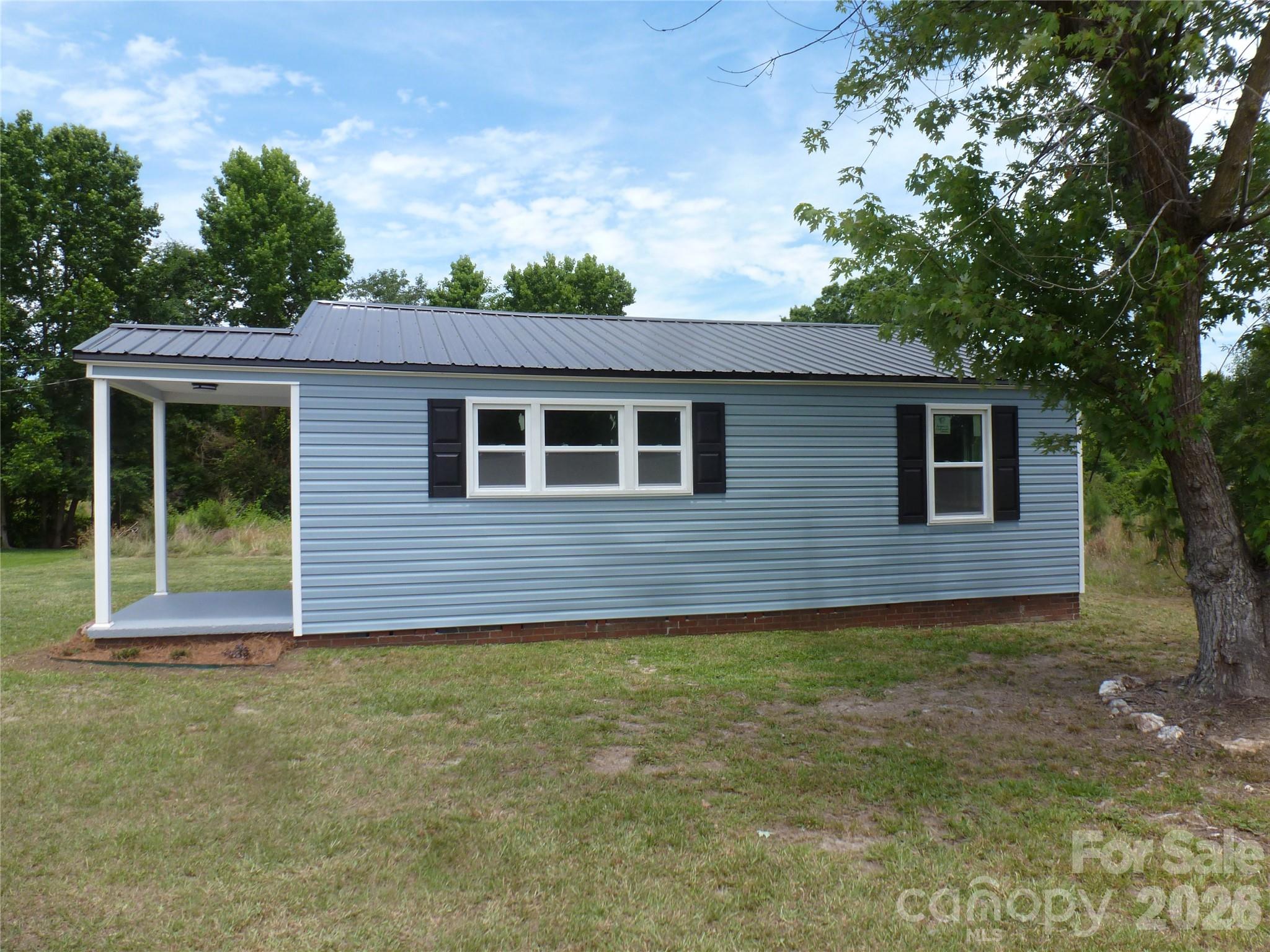 Completely remodeled and move-in-ready Ranch on a 1/2 acre lot!  New metal roof, new vinyl siding, all new windows, new flooring throughout, freshly painted, remodeled bathroom, and new electric range.  The primary bedroom has a walk in closet and a 2nd smaller closet.  Great starter home!  A must see!