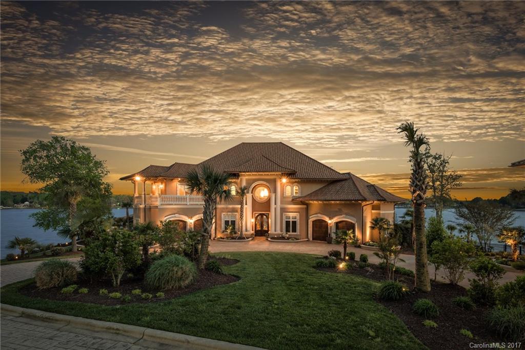 Spectacular private waterfront estate, some of the best views on Lake Norman! 8 car garage! 6 acre peninsula lot with long range panoramic lake views. Main house is 7000+ SF with 5 bedrooms (perks for 4), the separate guest house is 1800 SF with 2 bedrooms. This home has been completely remodeled inside and out with top of the line finishes. Italian marble flooring on main level. Infinity salt water pool & hot tub. Long private driveway. Fenced yard.  Private pier with boat slip & Lift.