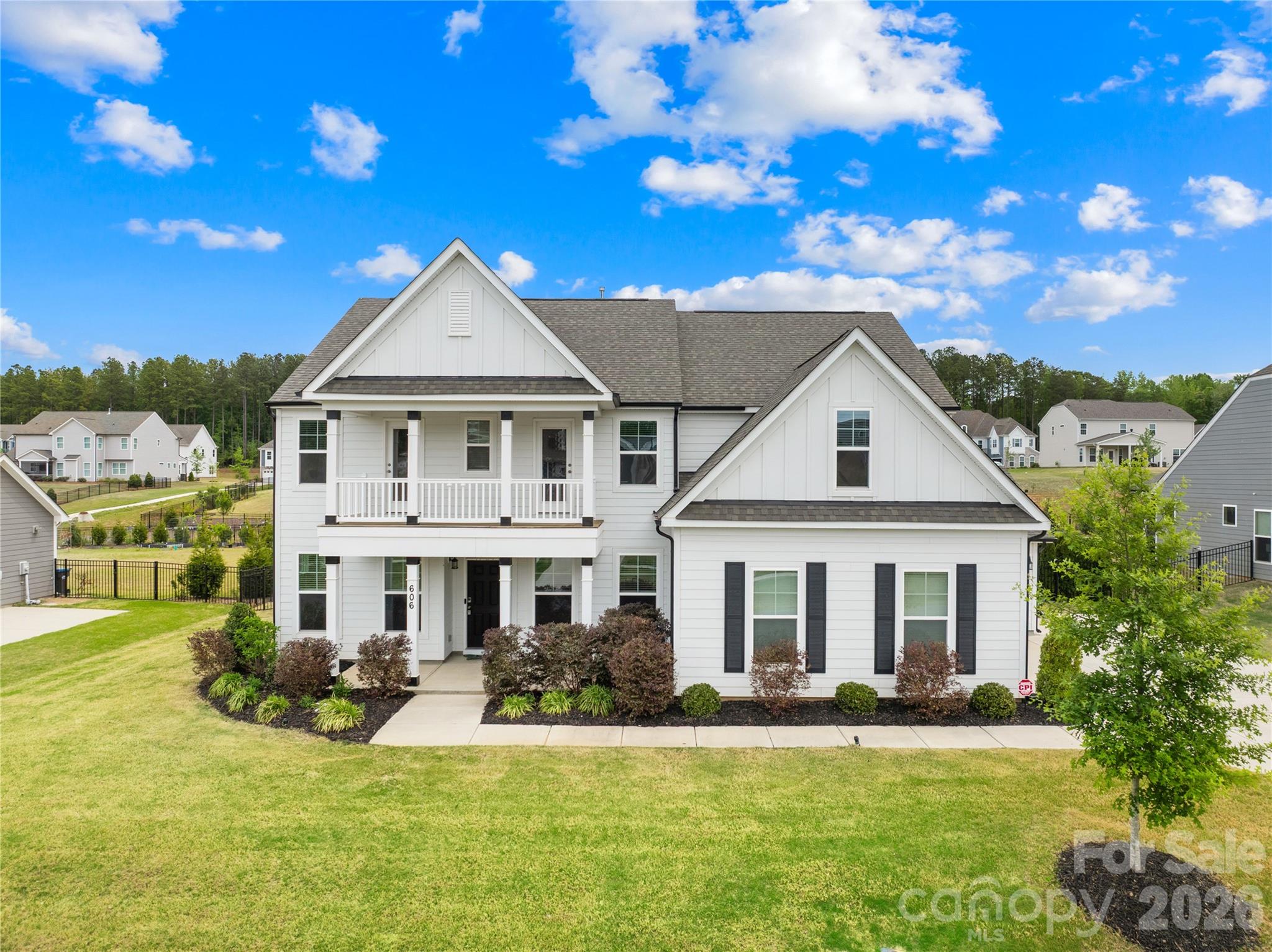 Move-in ready and like new 2022-built beloved Charleston floor plan with engineered hardwood flooring sits on a half-acre flat, fully fenced lot with privacy hedge in Waxhaw.

Located in the premier Wrenn Creek community of Waxhaw, this 3,776-square-foot of open, luxury living — five bedrooms, four full baths residence offers a home without a single inch of carpet. Instead, every room is finished with premium Palmetto Road Lake Ridge Sutton engineered hardwoods that are artisan hand-scraped planks in varying widths that flow seamlessly through every room sealed with eight coats of Valspar Ultra-Transparent Aluminum Oxide, offering a warm, elegant satin sheen that is as durable as it is beautiful.

The main level is designed for both everyday life and effortless entertaining. A private study with French doors creates a quiet and productive retreat, while the guest suite with a full bath ensures visitors feel right at home. The heart of the house is a beautiful open floor plan with a huge quartz countertop island that seamlessly leads into a gourmet kitchen equipped with white cabinets, quartz countertops, tile backsplash, farmhouse sink, pot filler, gas cooktop, wall oven, stainless steel appliances and a butlers pantry.

Upstairs, the primary suite offers a sprawling private wing with a true spa bath and generous walk-in closets. The laundry room is located directly adjacent to the primary suite, turning a daily chore into a seamless, effortless convenience. Three additional bedrooms, a large bonus room ready to become your dedicated cinema or crafts room. This home lives outdoors on both levels with a private upper front porch accessible directly from two secondary bedrooms—a perfect spot for morning coffee or evening breezes giving the home its own signature architectural moment.

Step outside into your 0.47-acre private sanctuary. A screened porch leads to an extended patio and a built-in fire pit with stone seating—three distinct outdoor living zones on a flat, fully fenced and landscaped with a dense and more than 120ft long hedge of Emerald Green arborvitae that creates a lush, year-round privacy screen giving the backyard the feel of a private retreat.

A side-entry two-car garage plus an additional garage, community pool, cabana, playground, and walking trails complete the picture. Wesley Chapel shopping (Target, Harris Teeter, restaurants, etc.) is five minutes away; downtown Waxhaw is under ten.

Skip the construction delays and the "new build" dust. No projects. The only thing missing is your furniture.