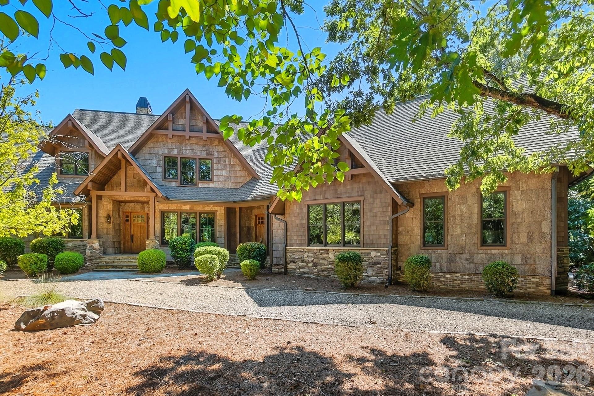 Nestled on 2.27 wooded acres in The Sanctuary at Lake Wylie, this one-of-a-kind luxury retreat blends exceptional craftsmanship, rustic elegance, sustainable design, and rare expansion opportunity. Thoughtfully curated with enduring materials, the home’s many impressive features include authentic maintenance-free Poplar Bark siding with a 75+ year lifespan, reclaimed barn wood accents, stone tile, engineered hardwood flooring, solid walnut cabinetry, a tankless water heater, and a greenhouse designed for year-round cultivation. At the heart of the home, an AGA Legacy range anchors a chef-inspired kitchen, complemented by rich architectural detailing and bespoke finishes throughout. Outdoor living is equally intentional, with a pristine saltwater pool tucked into the wooded landscape, creating a private retreat fully immersed in nature. Designed for current main-level living as well as for future expansion, the home offers approximately 3,521 of finished sq. ft along with roughly 1,030 sq ft of adaptable space under the existing roofline. An unfinished 4th bedroom with 4th en suite bath and a separate unfinished bonus room with full bath are already plumbed and wired offering a seamless opportunity to add both living area and instant equity potential. And, while you experience living in unmatched privacy & natural beauty, also enjoy access to The Sanctuary’s 17-acre waterfront amenity complex, featuring a resort-style pool, tennis and pickleball courts, play area, 24-hour fitness center, community boat slips, and miles of peaceful walking trails along beautiful Lake Wylie.

HOA dues of $1464/qtr plus $75/semi-annually for required septic inspection. Exterior is Poplar Bark Shingle siding, which is maintenance-free, anti-microbial and regeneratively manufactured. House was wrapped & roof felted underneath the bark. Exterior feature: 114 sf greenhouse with plumbing.