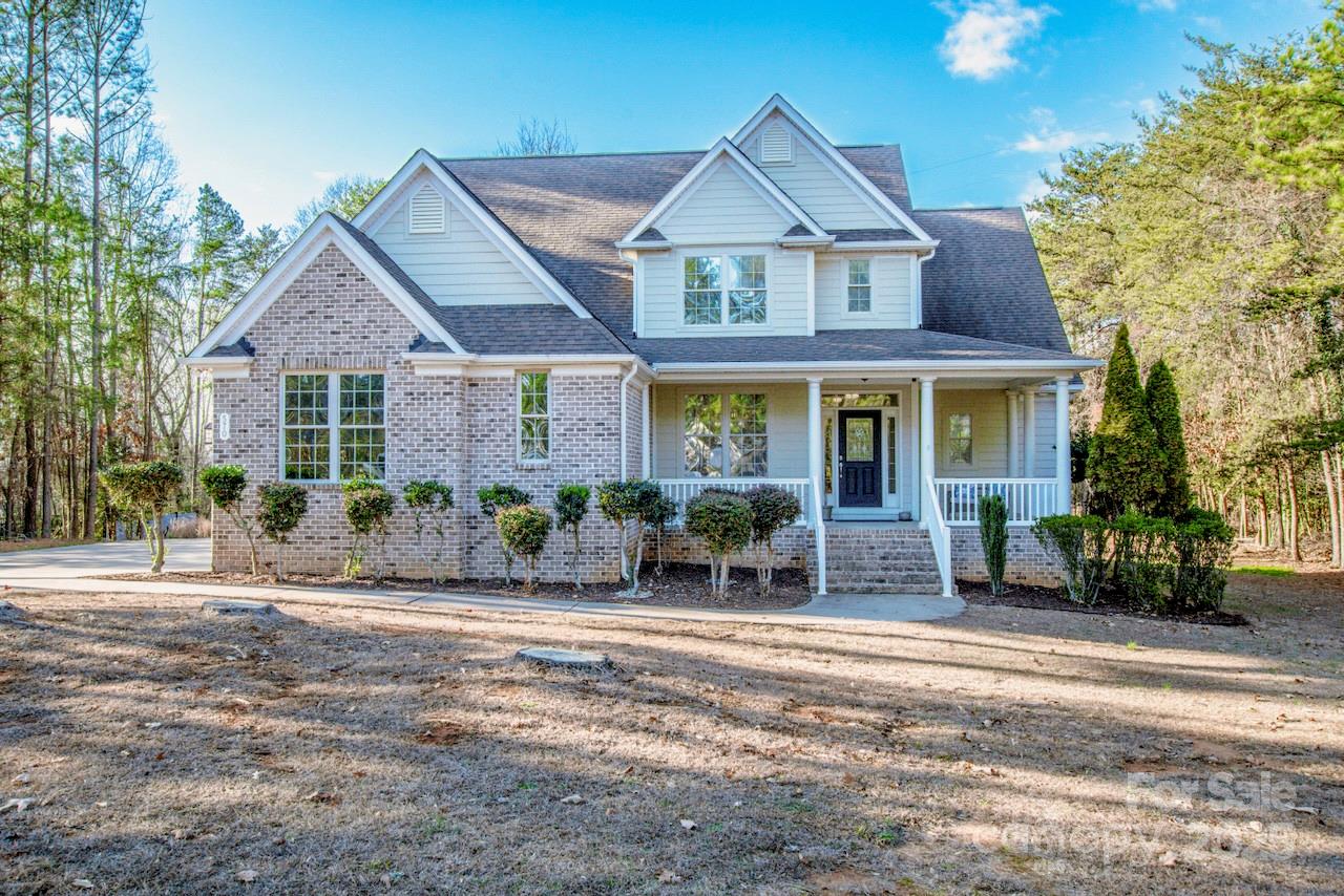 This beautifully appointed home sits on a flat, nearly one-acre lot and offers exceptional craftsmanship and thoughtful design throughout.  Inside, you'll find upscale and unusually gorgeous kitchen countertops with 42' cabinets, instant hot water and eat-in bar area.  Extensive crown molding and custom trim add elegance at every turn, while abundant storage keeps everything organized. Surround sound can be enjoyed in the Great Room.  The spacious primary suite on the Main level, features a stunning trey ceiling, bath with a garden tub with tiled wall, comfort height dual sinks and a private water closet. Upstairs, an enormous loft with a charming dormer and addl surround sound creates a flexible living space, along with three generously sized bedrooms, one ideal for a home office and two beautifully up-fit Baths. A well-designed laundry room includes it's own sink and exterior access.  Outdoor living is just as impressive with a charming front porch, an expansive composite back deck, that steps down into the large backyard, perfect for relaxing or play.  You will enjoy country feel, not-too-far from town.  Enjoy lake access and hiking trails within 2 miles at the gorgeous Lake Norman State Park.