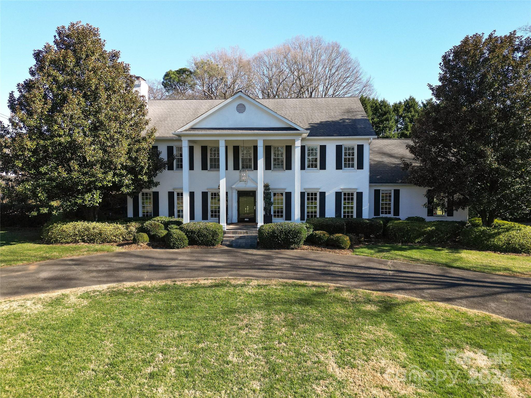 This stately brick home sits on 1.57 acres in one of Charlotte’s most sought after SouthPark neighborhoods. High ceilings, large formal & informal spaces. The downstairs features a large inviting foyer, spacious dining & living rooms, & paneled office. The beautifully updated Kitchen & breakfast area opens to a bright & sunny family room that overlooks a large private backyard. French doors access a bluestone terrace that offers several different entertaining areas for dining alfresco, enjoying a fire on the covered porch or spending time in the pool. A bonus room above the garage provides another recreation space for game nights or a cozy tv room. The Primary bedroom & ensuite bathroom are located on the upper level along w/3 additional bedrooms & baths. Great backyard has detached potting shed & raised bed gardens areas. The circular driveway features electronic gates & is enclosed by a brick wall along the front of the home. It is a rarity to find a lot this size!