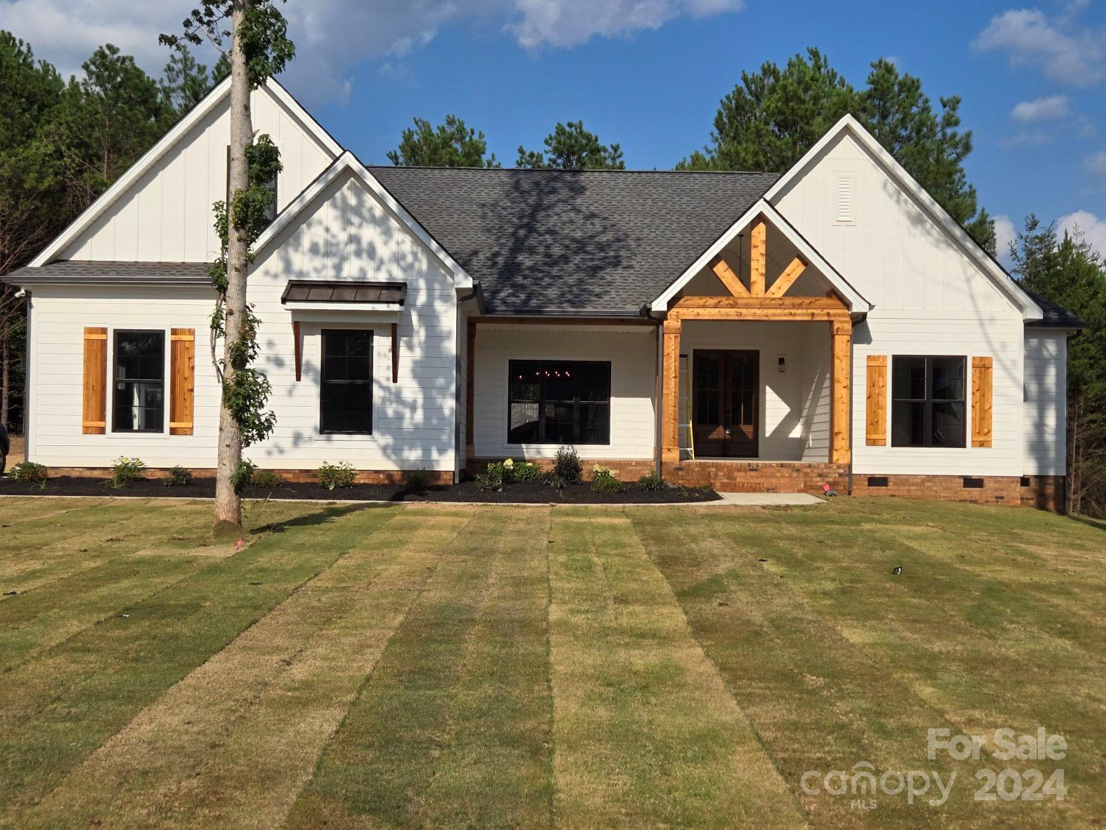The Pine Knoll is a gorgeous newly constructed home located in Rock Hill, SC. Built by Waddell Custom Homes, LLC, this home has 4 bedrooms and 4.5 bathrooms along with a bonus room or option for an office space. With plenty of natural lighting and an open kitchen and living space, you can live abundantly. The little things matter, so feel like you live in luxury with all this home and property have to offer like 1.07-acres with front sod and irrigation, two-car side-load garage, screened back porch, and a front elevation with stunning wood accents. The Pine Knoll offers a comfortable space to call home while also being beautifully designed with you in mind. This house is located in Heartland Acres off of Adnah Church Road, a well-developed but newly expanding subdivision at the back of Wellington Heights II. Constructed with care, this one-of-a-kind abode is ready for you!