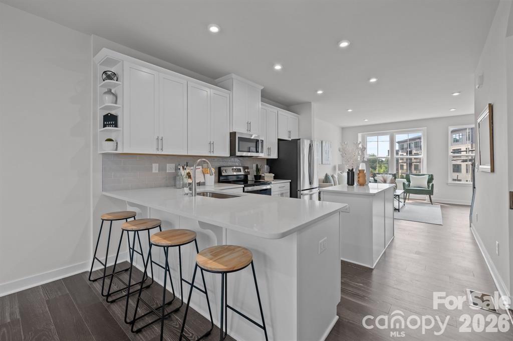Seller is offering 10k in concessions! Preferred lender, offering 10k incentives! Welcome to this like-new construction townhome in the heart of LoSo, built by Ryan Homes and never lived in offering the rare opportunity to own a pristine, move-in ready home without the wait. This beautifully designed 3-bedroom, 3.5-bathroom home features a modern open-concept layout filled with abundant natural lighting and enhanced by recessed lighting throughout, creating a bright and inviting atmosphere. The kitchen is a true centerpiece, showcasing sleek finishes, a spacious island, and GE appliances, perfect for both everyday living and entertaining. A lovely resort style primary shower, double vanity, and ample cabinet space.  

Investor friendly, rental potential, please email listing agent for rental projections. 

Enjoy thoughtfully designed spaces including generous walk-in closets, ample storage throughout, and a 2-car garage with additional storage space—providing both functionality and convenience.

Step outside to not one, but two outdoor living areas: a rear balcony off the dining room, ideal for morning coffee or evening wind-downs, and a private rooftop terrace with stunning LoSo views, perfect for entertaining or relaxing above the city. This area is very walkable!

This well-maintained home offers the feel of a model with elevated finishes and a fresh, untouched living experience.

Located in a prime location within one of Charlotte’s fastest-growing areas, you’re just minutes from LoSo’s vibrant breweries, restaurants, and entertainment, with quick access to South End, Uptown, I-77, I-485, and the light rail.

Experience modern living, thoughtful design, and unbeatable location—all in one. Schedule your showing today!