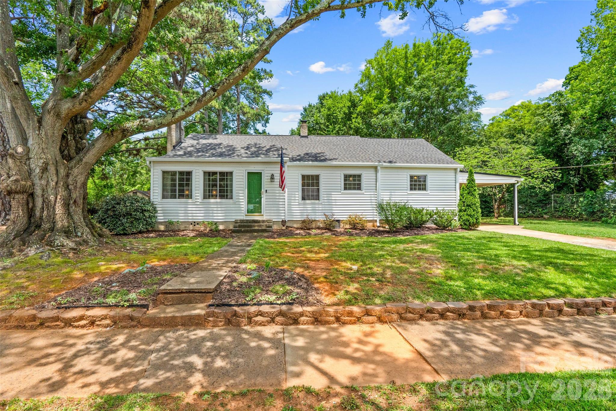 Welcome to 1019 Beverly Drive! This charming 3-bedroom home is nestled in one of Rock Hill's most desirable locations, just moments from Winthrop Lake, Winthrop University, shopping, dining, and everything downtown has to offer. Blending timeless character with thoughtful improvements, this home features warm hardwood floors, a spacious living room with a cozy fireplace, a dedicated dining room, and a beautifully refreshed kitchen with abundant cabinetry, generous counter space, and room for casual dining.

The versatile floor plan also features a bright sunroom overlooking the backyard and a stunning bonus room with rich blue paneling, currently used as an office but could be used as a bedroom, playroom, or additional living space.

Step outside to enjoy the private, fully fenced backyard featuring a paver patio, mature shade trees, a metal storage shed, and a workshop/storage room attached to the carport. Bordering Winthrop Lake, the property offers a peaceful setting with nature just beyond your backyard.

Major improvements include a new roof (2025), gutters (2025), window wraps (2025), gas pack HVAC (2021) with transferable warranty, all new ductwork (2021), a new sewer line (2021), and a transferable Terminix service. 

Move-in ready and full of character, this home offers the perfect blend of classic charm, modern updates, and an unbeatable location near Winthrop Lake.