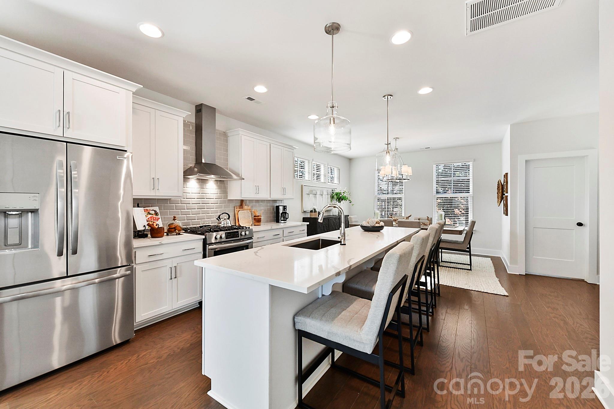 Welcome to the heart of Davidson, North Carolina’s Historic District, where timeless charm meets modern, low-maintenance living. This spacious, light-filled townhome offers an exceptional opportunity to enjoy one of the most walkable and desirable communities in the Lake Norman area—just steps from downtown shops, dining, the farmers market, and year-round community events.
Perfectly positioned within the community, this home offers both connection and privacy. Out the front windows, you’ll enjoy peaceful views of community greenspace, creating a natural, open feel. Out back, a mature line of trees provides a serene buffer, offering privacy and a quiet retreat that feels tucked away while still being close to everything.
From the moment you enter, the home feels open, bright, and thoughtfully designed. The first floor includes a welcoming foyer, a convenient drop zone, and interior garage access. A private bedroom and full bathroom on this level provide excellent flexibility for guests, a home office, or multigenerational living. The garage also features an electric vehicle charger, adding modern convenience for today’s lifestyle.
The second floor is the heart of the home—an open-concept living space filled with natural light. The spacious kitchen features luxury finishes and flows seamlessly into the dining area and large family room, creating an ideal layout for everyday living and entertaining. Bump-out windows in the dining area add charm and dimension, creating the perfect nook for a cozy reading bench or a bright seating space to enjoy the outdoor views. Just off the family room, a quaint covered patio offers a peaceful retreat for morning coffee or evening relaxation.
Upstairs, the third floor continues the thoughtful design with a generous primary suite featuring two walk-in closets and a well-appointed en-suite bath. The primary bedroom also includes a bump-out window, enhancing natural light and offering the perfect space for a reading corner or peaceful sitting area. A second bedroom on this level includes its own private en-suite bathroom, providing comfort and privacy for family or guests. A dedicated laundry room on the third floor adds everyday convenience right where you need it most.
Living here means more than just a beautiful home—it’s a lifestyle. Enjoy strolling to the Davidson Farmers Market, exploring boutique shopping and award-winning restaurants, or taking part in the town’s vibrant calendar of festivals, concerts, and seasonal events. All of this, paired with low-maintenance townhome living, allows you to fully enjoy everything Davidson has to offer.
Elegant finishes, an open and airy floor plan, thoughtful architectural details, and a premier location come together to create a home that captures the essence of Davidson living—sophisticated, walkable, and effortlessly connected.
Please Note: Photos are representative of the home when newly built and are intended to reflect the floorplan, finishes, and the property’s well-maintained condition. These photos are representative of an end unit, and design selections, window placement, and floor plan orientation may vary.