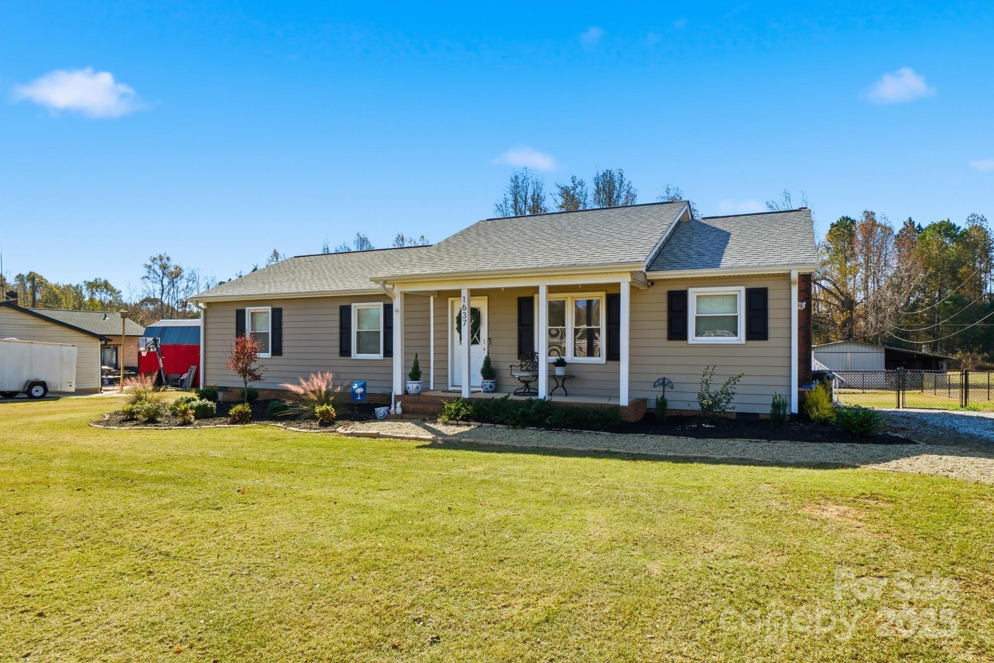 Looking for more yard space than a traditional neighborhood can offer? Welcome home to this charming one-level, 3-bedroom, 2-bath home on over an acre of land, as cute as can be! Enjoy a fenced backyard, outbuilding/workshop, and plenty of open, level yard space for kids of all ages to garden, play ball, or simply unwind in this peaceful country setting. You’ll love the tranquility while staying close to award-winning Clover schools and all the nearby conveniences of local restaurants, grocery stores, and shopping. With easy commutes to Lake Wylie, Rock Hill, York, Gastonia, and Charlotte Douglas International Airport, this property offers the perfect blend of space, comfort, and convenience. No HOA! The home features numerous upgrades, including new windows, roof, HVAC system, well pump, and tankless water heater, all of which were completed within the last four years. Come love where you live!