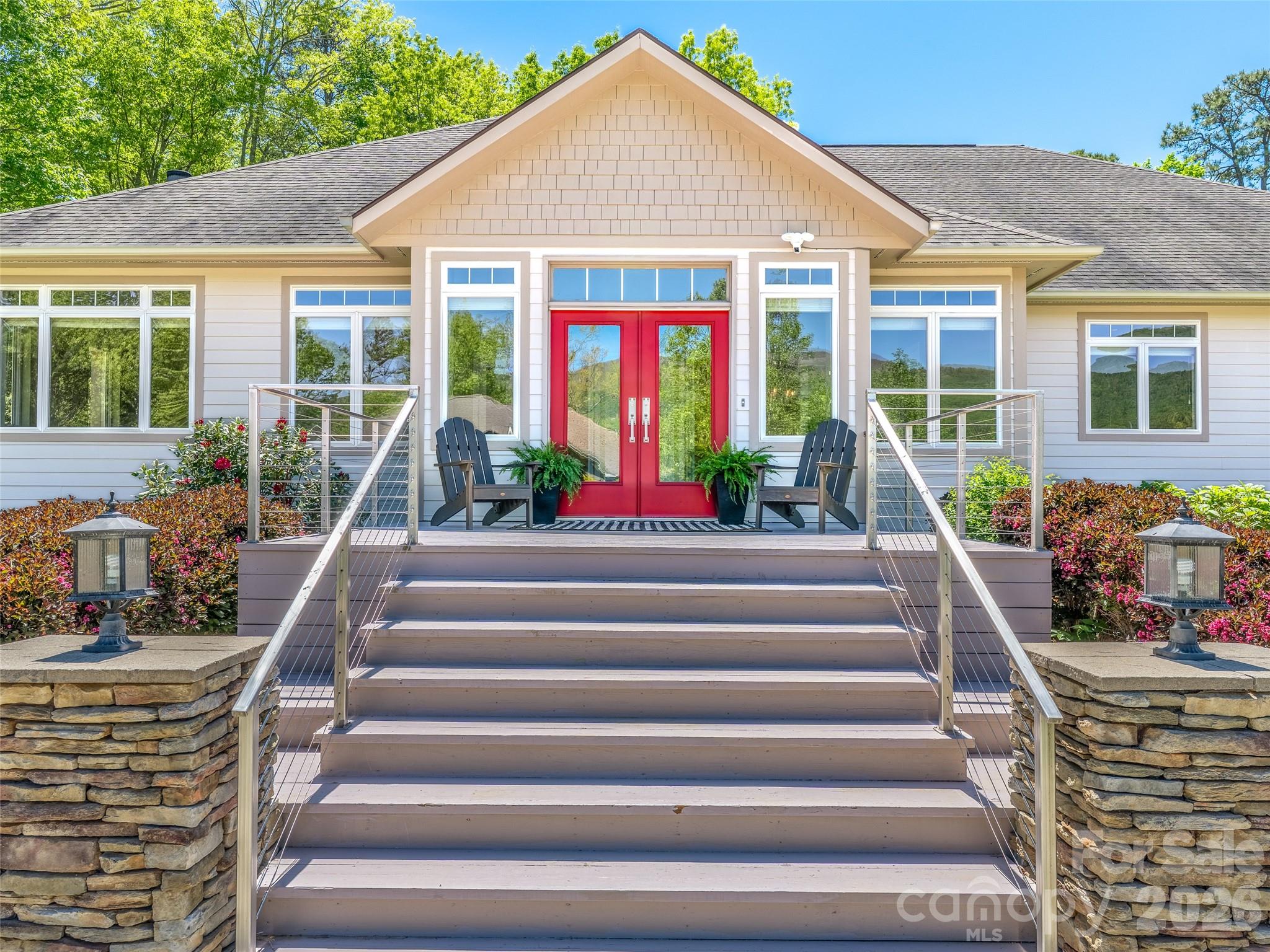 Nestled in a peaceful mountain setting of Fairview, this thoughtfully designed home offers an ideal balance of privacy, comfort, and convenience. Surrounded by year-round mountain views—including Flat Top and Little Pisgah—the property features inviting indoor and outdoor living spaces ideal for both everyday living and entertaining. Enjoy quiet mornings in this small enclave neighborhood, sipping coffee outdoors surrounded by the sounds of nature, and evenings watching sunset light across the mountains as owls emerge at dusk.

Designed for single-level living and aging in place, this home offers three ensuite bedrooms, wide doorways and hallways, and thoughtful accessibility features including reinforced bathroom walls and a removable garage ramp. Quality construction includes 2x6 exterior walls for enhanced insulation, 10-foot ceilings, and 8-foot entry doors, creating a spacious and comfortable environment throughout.

Interior finishes are both distinctive and elevated, featuring rare bamboo flooring, cork flooring in the kitchen, and brand-new white oak hardwoods in the main living areas. A striking stone fireplace with a gas starter and adjoining wood shed anchors the living space. A dedicated study with built-in bookcases, a pocket door, and stunning mountain views provides the perfect space for work or quiet retreat. A spacious sunroom offers an inviting setting for mountain viewing, plants, reading, crafts, puzzles, and hobbies year-round.

Designed to entertain with ease, the kitchen is exceptionally well-appointed with double wall ovens, a large range with a custom buffet cover, a butler’s pantry, ice machine, and dual sinks, offering the ability to comfortably host gatherings of 50+ guests.

Outdoor living is equally impressive, with a low-maintenance yard that functions as a true gardener’s paradise. Mature plantings include established fruit trees, berry bushes, grapevines, and ornamental landscaping, creating beauty and productivity in every season.

Additional highlights include a massive 4-car heated and cooled garage or workshop space, three separate driveways for ample parking, and a hardwired generator for peace of mind. Located on a publicly maintained road with low HOA fees, the property offers both accessibility and ease of ownership.

Ideally situated just 20 minutes to downtown Asheville, 15 minutes to Asheville Regional Airport, 20 minutes to Black Mountain and Lake Lure, this home delivers the tranquility of mountain living with convenient access to dining, shopping, and recreation. https://youtu.be/MLVV0kYajmM
