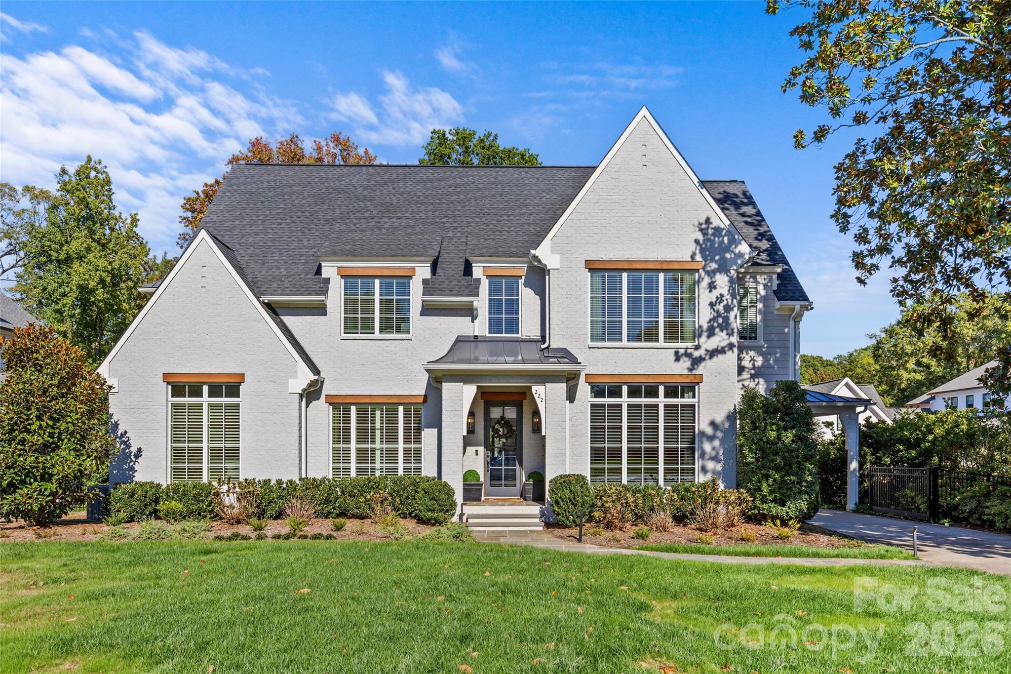 This stunning turn-key Cotswold residence lives like new construction without the price tag- the home is truly move-in ready and shows beautifully throughout. Situated on a professionally landscaped, manicured lot, the 5,485 SF home includes a detached garage suite with a fifth bedroom and full bath, offering exceptional flexibility for a guest suite, home office, gym, or additional living space. Thoughtful, high-end details are found throughout, including designer lighting and window treatments, custom molding, 10’ ceilings on the main level, and white oak hardwood flooring. The main-level primary suite features an expansive custom closet with secondary laundry and a spa-inspired bath with a zero-entry shower. Light-filled, open living spaces center around the chef’s kitchen, appointed with Wolf/Sub-Zero appliances, quartz countertops, marble backsplash, and a built-in banquette, flowing seamlessly into the spacious family room with cozy gas fireplace. An impressive drop zone includes a walk-in pantry, wet bar, custom locker storage, and an adjacent home office. Formal dining and a welcoming sitting room complete the main level. Upstairs, enjoy three en-suite bedrooms, a large laundry room, flexible bonus space, and exceptional storage, including oversized closets and a dedicated storage room. Outdoor living is equally impressive, with a covered porch featuring a fireplace and motorized screens, overlooking the turfed backyard with putting green, fire pit, and outdoor kitchen. Room for a pool to create the ultimate backyard retreat (renderings available)! Thoughtfully priced relative to new construction and recent neighborhood sales, this exceptional home offers a standout opportunity in Cotswold and will not last long!