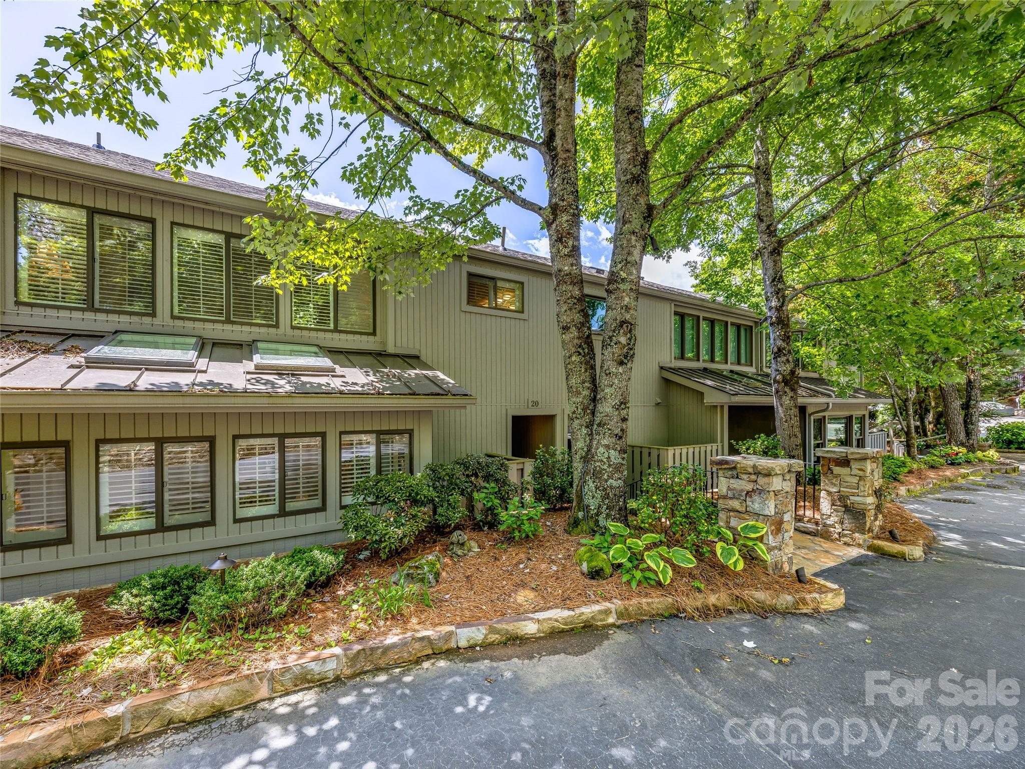 Coveted Toxaway Shores offering 2 bedrooms, 2 baths, plus a versatile bonus/flex room. Enjoy resort-style amenities including a tennis/pickleball area, fire pit, social center, and designated boat dock. Soaring cathedral ceilings and a native stone wood-burning fireplace add charm, while a beautiful flowering cherry tree provides shade and privacy. Overlooking an expansive lawn with an in-ground pool and lake just beyond—this is lake living at its finest. Membership to LTCC is based on application and availability.