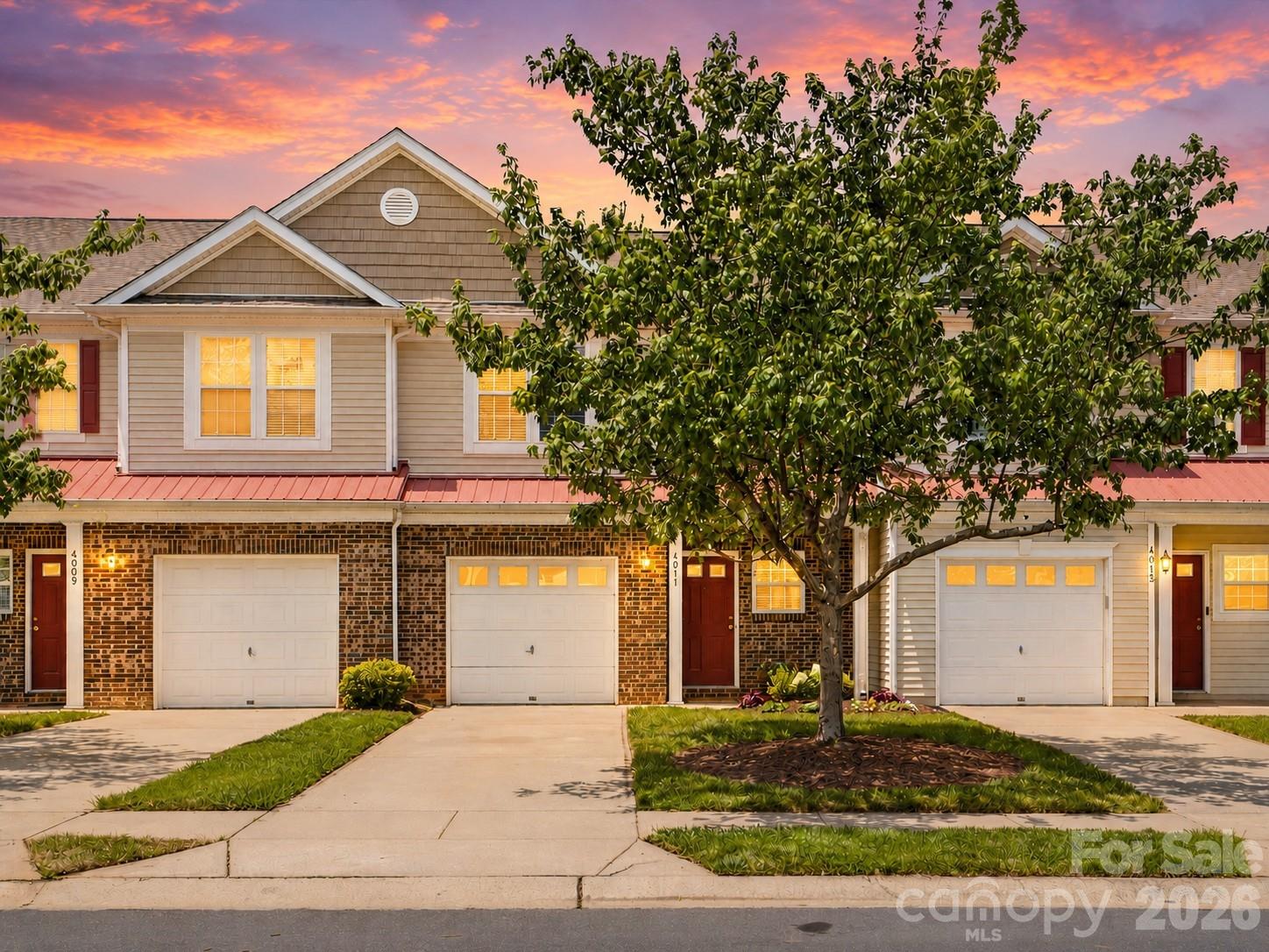 Beautifully renovated and move-in ready, this spacious 3-bedroom, 2.5-bath townhome in the sought-after Arlington community offers stylish updates and low-maintenance living in the heart of Indian Land. Freshly painted throughout, the bright, open floor plan is filled with natural light and features luxury vinyl plank flooring throughout the main level, custom dining room wainscoting, and a stunning gas fireplace with a shiplap feature wall and rustic wood mantel to create warmth to the living area. Expansive windows and French doors overlook a peaceful green space, bringing the outdoors in.  The gorgeous kitchen is the heart of the home, featuring updated cabinetry, countertops, subway tile backsplash, stainless steel appliances, modern fixtures, and a large center island perfect for entertaining and everyday living. Upstairs, you'll find new carpet throughout, a spacious primary suite with vaulted ceiling, generous secondary bedrooms, and a conveniently located laundry area.  Step outside to enjoy the private patio and attached storage area, all while backing to a beautifully maintained open common area that provides a sense of space and privacy. Additional features include a one-car garage and ample guest parking.  Residents of Arlington enjoy outstanding amenities including a community pool, clubhouse, recreation area, and sand volleyball court. Ideally located near Ballantyne, shopping, dining, and major commuter routes, this turnkey home offers the perfect blend of comfort, style, and convenience.