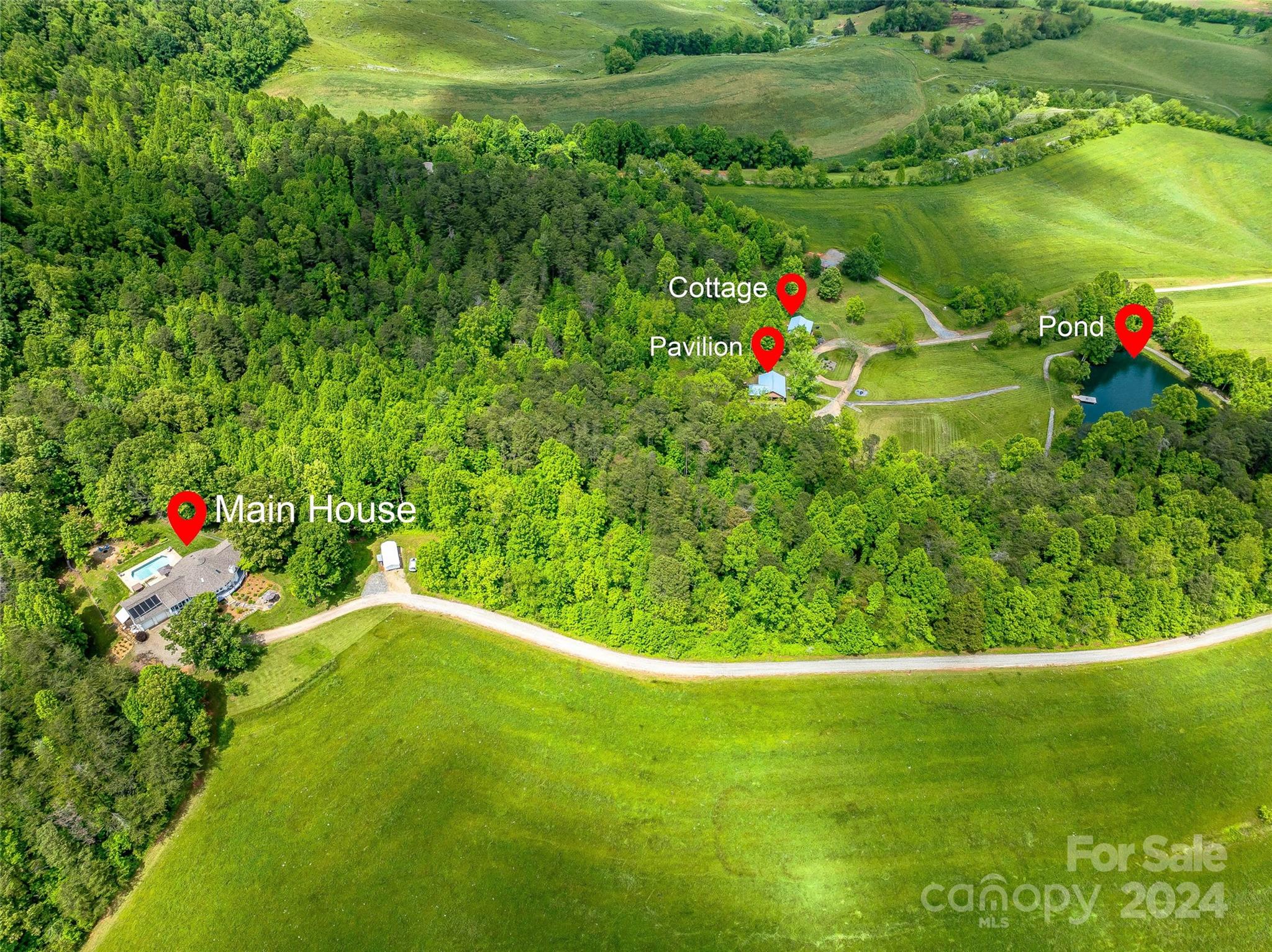 Discover your dream retreat on 102 breathtaking acres, just 20 minutes from downtown Asheville. This stunning property features rolling pastures & panoramic mountain views, creating a serene and picturesque escape.  Adjacent to hundreds of acres of conservation land. Main house with pool, guest cottage (used as Airbnb) & Pavilion (used for events).  Enhance your outdoor living with a tranquil pond, ideal for fishing or simply enjoying the peaceful ambiance set against the backdrop of natural beauty or wander through rolling pastures or maintained scenic walking/ATV trails. Whether you envision a private sanctuary, a family compound, equestrian estate, development opportunity, retreat center, farm for livestock or a unique event venue, this versatile estate offers endless possibilities. Embrace the best of both worlds with rural tranquility & easy access to Asheville’s vibrant culture, dining, and entertainment. Don’t miss the opportunity to own this extraordinary piece of paradise!
