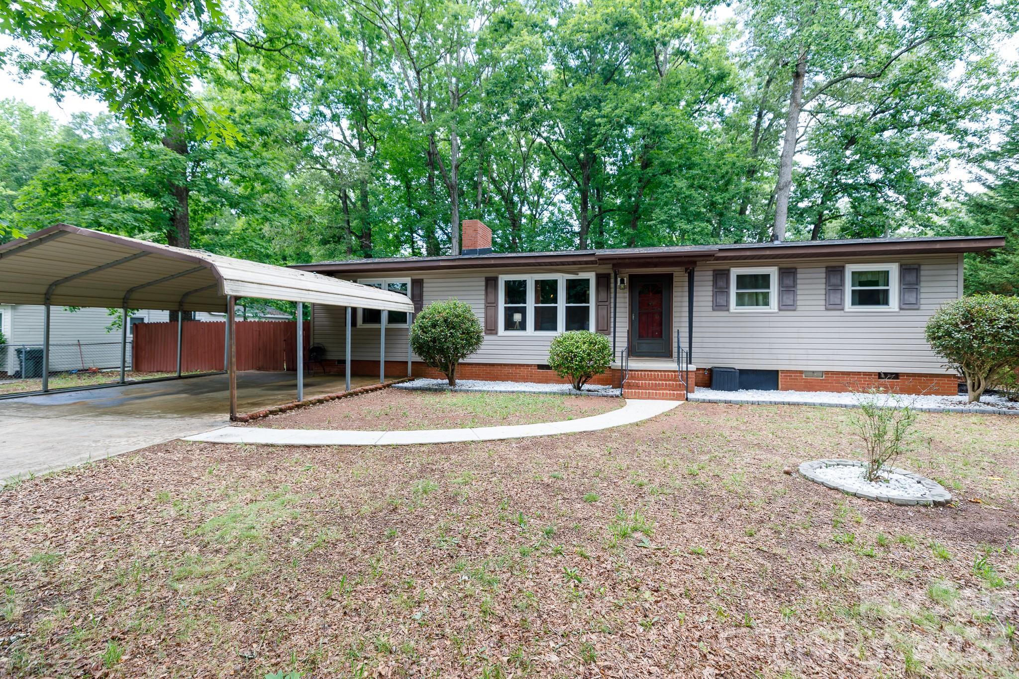 Welcome home to this charming, established ranch in York, complete with a new roof installed in 2025. Step inside to a warm, inviting living room featuring vaulted ceilings, classic wood paneling, and a cozy fireplace that naturally anchors the space. The thoughtful layout offers a split bedroom plan for extra privacy. The kitchen offers plenty of room to move around, complete with a dedicated pantry and a spacious dining area made for unhurried morning coffee or casual weeknight dinners. Right off the back, the screened porch, small patio, and deck give you the perfect setup for relaxing outdoors in your peaceful, private backyard. Outside, the property is smartly cross-fenced, including a dedicated rear privacy-fenced area that is ideal for pets or play. With a detached two-car carport, a handy wired storage shed, and no HOA, you have the freedom to truly make this property your own.
