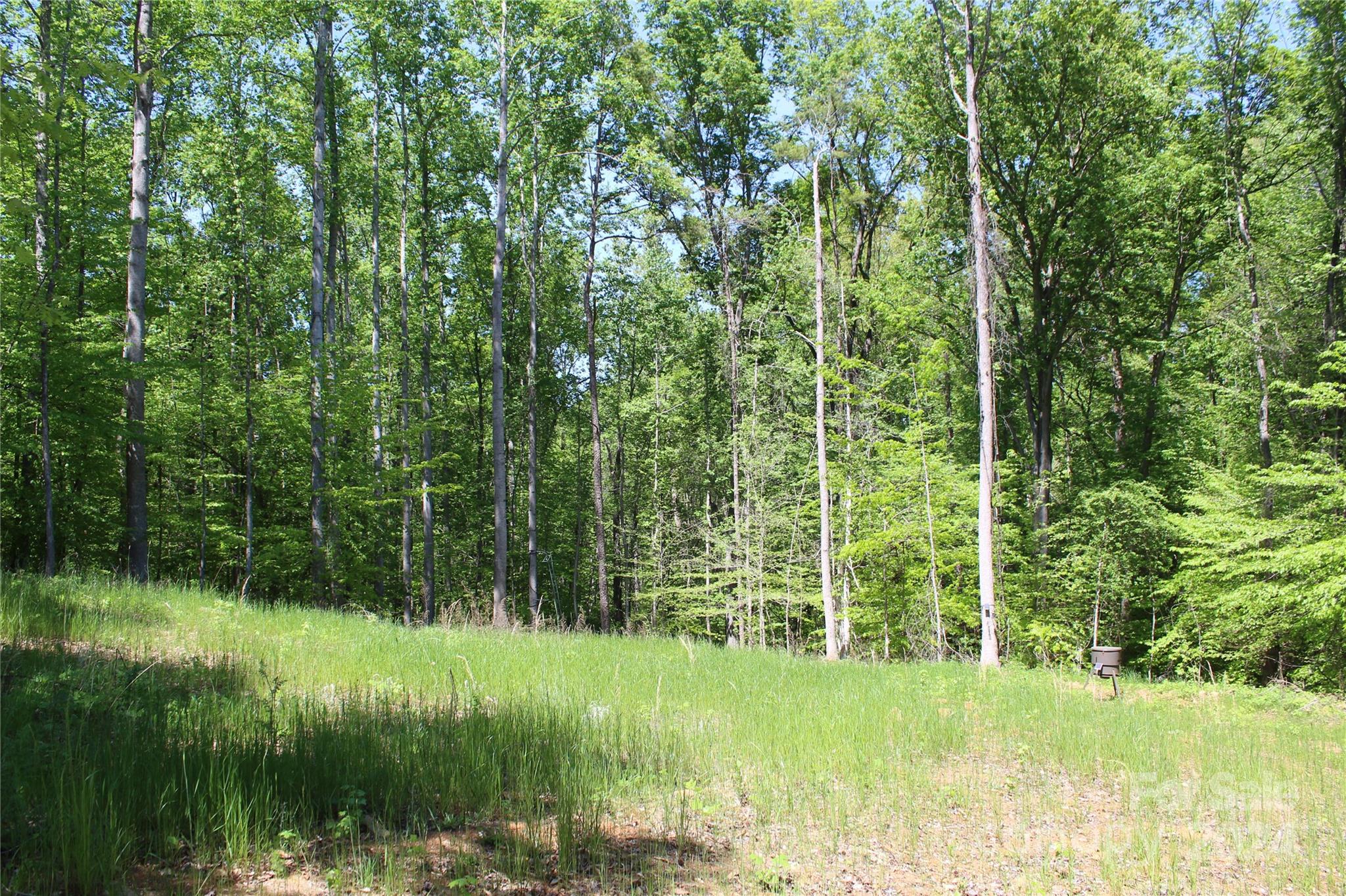 Don't miss this fantastic lot in Clover that is perfect for a walk-out basement home build!  This large 2.1 acre lot has been partially cleared for an approximately 1 acre home site and has an approved 4 bedroom septic permit so you are ready to build.  There is no HOA and minimal build restrictions so you are free to build your dream home.  The lot has beautiful hardwood trees, a gentle slope, natural drainage at the back, and touches a stream on the back left corner. The location within the sought after Clover School District is ideal and it's convenient to 1-85, Lake Wylie, York, Kings Mountain, Clover, etc.  Additionally, there are no city taxes!  Bring a builder with you or contact the listing agent for a builder perfect for this lot/location.  A survey, approved septic permit, and CCR's are attached for review.  Schedule a showing today!