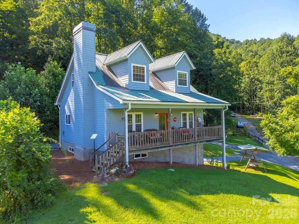 Nestled on 2.83± acres of gorgeous pasture land with a vintage barn, this charming 3-bedroom, 3.5-bath farmhouse offers the perfect setting for your mini farm dreams. This gorgeous farmhouse offers a stunning riverstone fireplace, soaring cathedral ceilings, and solid 6-panel wood doors throughout. The main floor boasts a spacious primary suite with a private bath. Upstairs, the open loft includes a bedroom, full bath, and office, ideal for remote work, guests, or a cozy reading nook. The fully finished daylight basement provides an apartment complete with its own living room, kitchen, bedroom, bath, laundry, and flex space, perfect for multi-generational living or income-producing potential.  Enjoy peaceful mornings and golden hour sunsets from the front porch. Owners just installed a new heat pump! Located just over 3.5 miles to Harrah's Cherokee Casino and just minutes to Bryson City, Sylva, Maggie Valley and the Great Smoky Mountains National Park, this is the perfect location to enjoy all WNC has to offer.