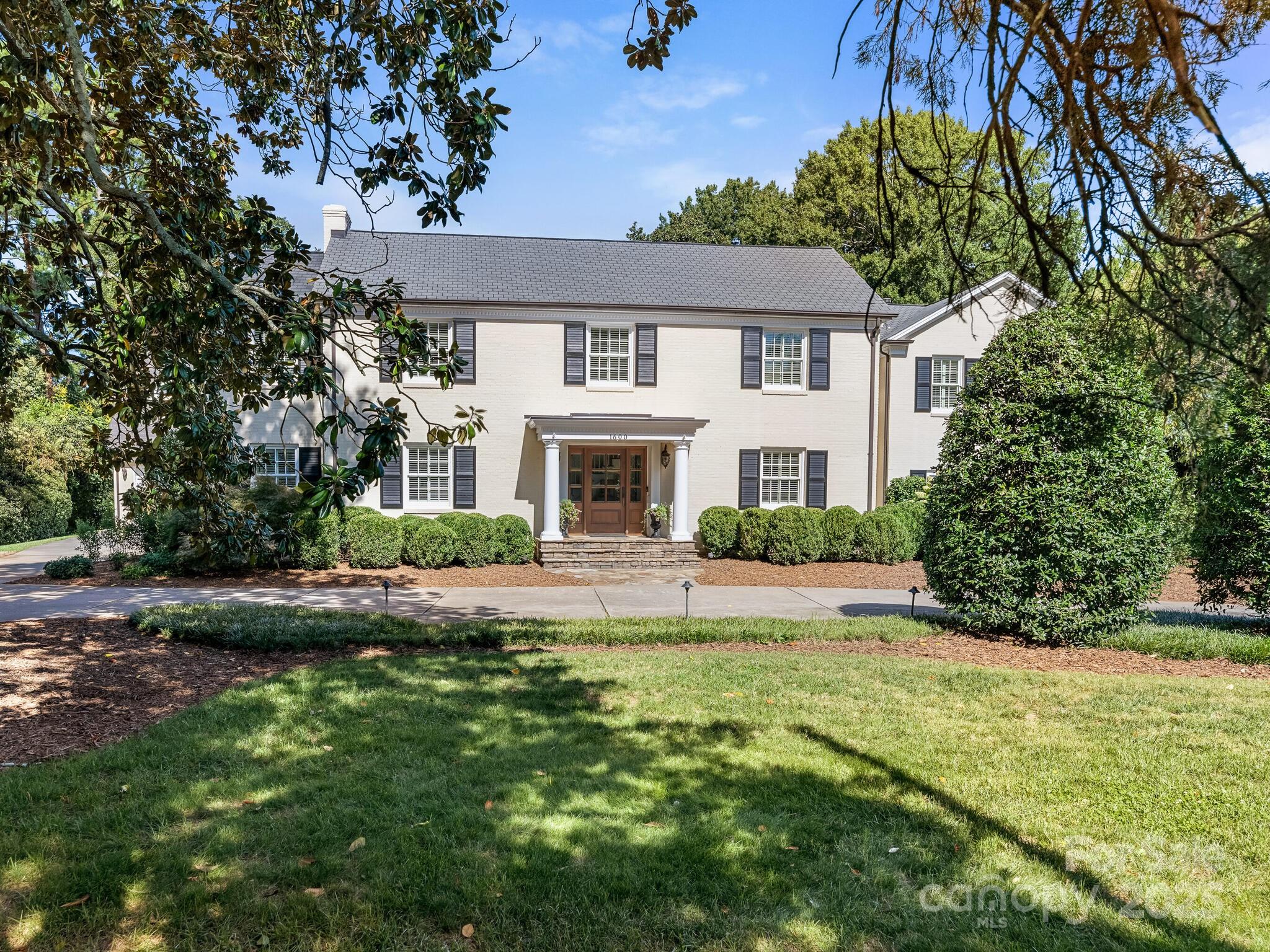 Classic curb appeal, excellent condition, sports court, and 1-plus acre park-like setting! An ideal blend of privacy, space, comfort, and versatility. Beautifully updated with hardwoods on both levels (including the guest houses), extensive millwork, built-ins, four fireplaces, fresh interior paint, a custom wet bar, and excellent natural light. Stunning kitchen with commercial-grade appliances, stone countertops, a large island, an Integrated Miele coffee maker, and a breakfast area. 
Awesome primary suite with vaulted ceiling, two custom-crafted walk-in wardrobes, fireplace, serene bath, and walk-out terrace overlooking the rear yard. All upper-level bedrooms have recently renovated en suite baths and Walk-in closets.  Large covered patio with cooking station and ample seating area is centered by an outdoor fireplace. 
Separate, well-appointed living quarters are located both behind and above the 3-car garage, offering flexibility and solitude for guests or extended family. Just Minutes to Uptown, SouthPark, and Cotswold Shopping Center--A "rare find", this close-in!