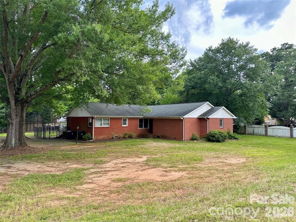 Positioned along one of Huntersville’s most traveled corridors, this rare 0.85-acre property offers the perfect blend of residential comfort and future potential.

This 3-bedroom, 2-bath brick ranch spans over 2,200 square feet and features expansive living spaces, a generous primary suite, and a layout ideal for modern updates or reconfiguration. The detached two-car garage/workshop adds exceptional flexibility for storage, workspace, or entrepreneurial use.

Step outside to a large fenced backyard with ample room for entertaining, expansion, or outdoor enjoyment. With no HOA, city utilities, and strong visibility along Sam Furr Road, this property stands out as a strategic opportunity for both homeowners and investors alike.

Explore the potential—whether as a primary residence, rental investment, or future commercial consideration (buyer to verify zoning and use).