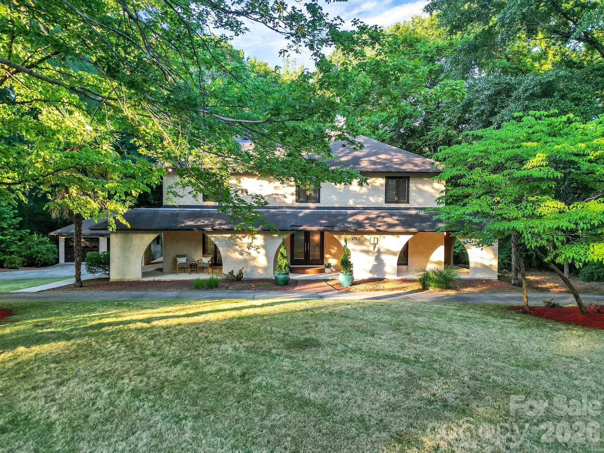 Welcome Home to this Amazing Mediterranean-style Home that blends timeless character with exceptional modern comfort. Privately nestled on 1.8 wooded acre Cul-de-Sac, this beautiful, elegant home has a thoughtfully designed living space, creating an ideal setting for both quiet retreat and sophisticated entertaining. This 1978 Custom Built Home enjoyed extensive renovations in 2008. This Home Showcases Custom designer features that include a fully remodeled Chef’s Kitchen with Designer Cabinetry. The Premium Appliances include a Thermador Gas Cooktop, Oven, Microwave & Dishwasher, Sub-Zero Refrigeration, Stand-Alone Wine Cooler with Refrigerated Drawers, KitchenAid Ice Maker, and a Bang & Olufsen Sound System. The Main floor hosts two Natural Stone Gas Fireplaces located in the Living Room and Luxurious Primary Bedroom and Bath Suite with large Jacuzzi Tub and Steam Shower. The Beautiful Two-Story Glass Atrium allows abundant Natural Light into the Open Concept living area. The 2nd story includes Two Bedrooms, and an Incredible built-in Two-person Teak Sauna, and a fully equipped Media room/Office. The Professional Landscaped Exterior includes a Semi-Circular Diveway, Landscape Lighting, an expansive TimberTech Deck with an Outdoor Natural Gas Firepit, Speakers, and Full Irrigation. This Incredible Home is a Dream Location on Carmel Road past the Carmel Country Club, minutes to Southpark and Ballantyne. Professional Photos will be added.