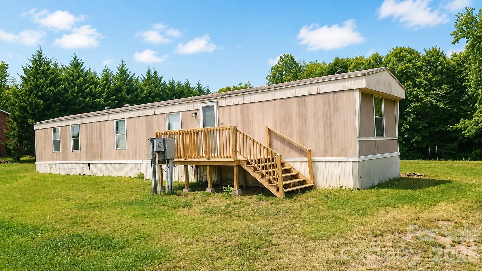 Looking for space, privacy, and value? This 1.193-acre property is situated just outside the Hickory Grove city limits and checks every box for the budget-conscious buyer ready to put down roots.
The 1996 single-wide mobile home features a split floor plan with two bedrooms and two baths, and offers several updates throughout.  The real bonus here is the large 24 x 40 workshop — a standout feature rarely found at this price point. The shop boasts a concrete floor, electrical service, and is plumbed for water- there is also a connected 16 x 30 lean-to for additional storage.   With just under 1.2 acres of open land, there’s room to garden, play with your farm animals, or enjoy the outdoors.  Title in hand.   Come on over to the country!!!