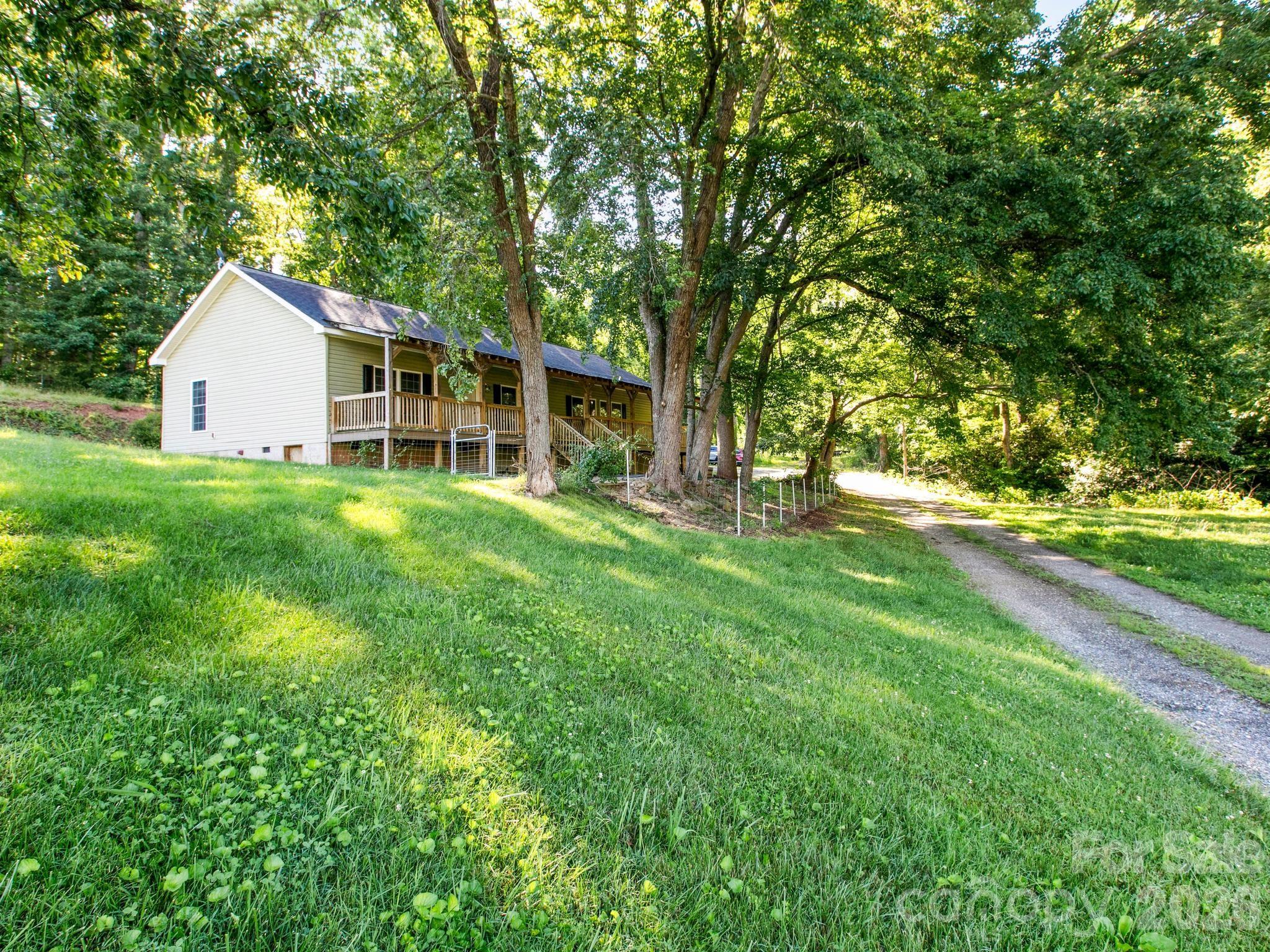 This one-level home offers the convenience buyers are searching for in one of Asheville's most desirable areas. Featuring 3 bedrooms and 2 full baths, the spacious floor plan is filled with an abundance of windows throughout the home. The property features a large covered front porch, perfect for relaxing and enjoying the outdoors, as well as a fenced front yard that provides added privacy, security, and space for pets or outdoor activities.

The heart of the home is the large kitchen, complete with ample workspace, generous cabinetry, and an oversized walk-in pantry that provides exceptional storage. The open living spaces flow seamlessly and create a warm, inviting atmosphere perfect for everyday living and entertaining.

Enjoy peaceful mornings and relaxing evenings on the expansive covered porch overlooking the surrounding property. Situated on approximately 0.7 acres, this home offers a wonderful balance of privacy and accessibility.

Just minutes from South Asheville shopping, dining, schools, and downtown Asheville, the location is truly what sets this property apart. If you've been looking for comfortable one-level living with ample space and an unbeatable location, this is the one!