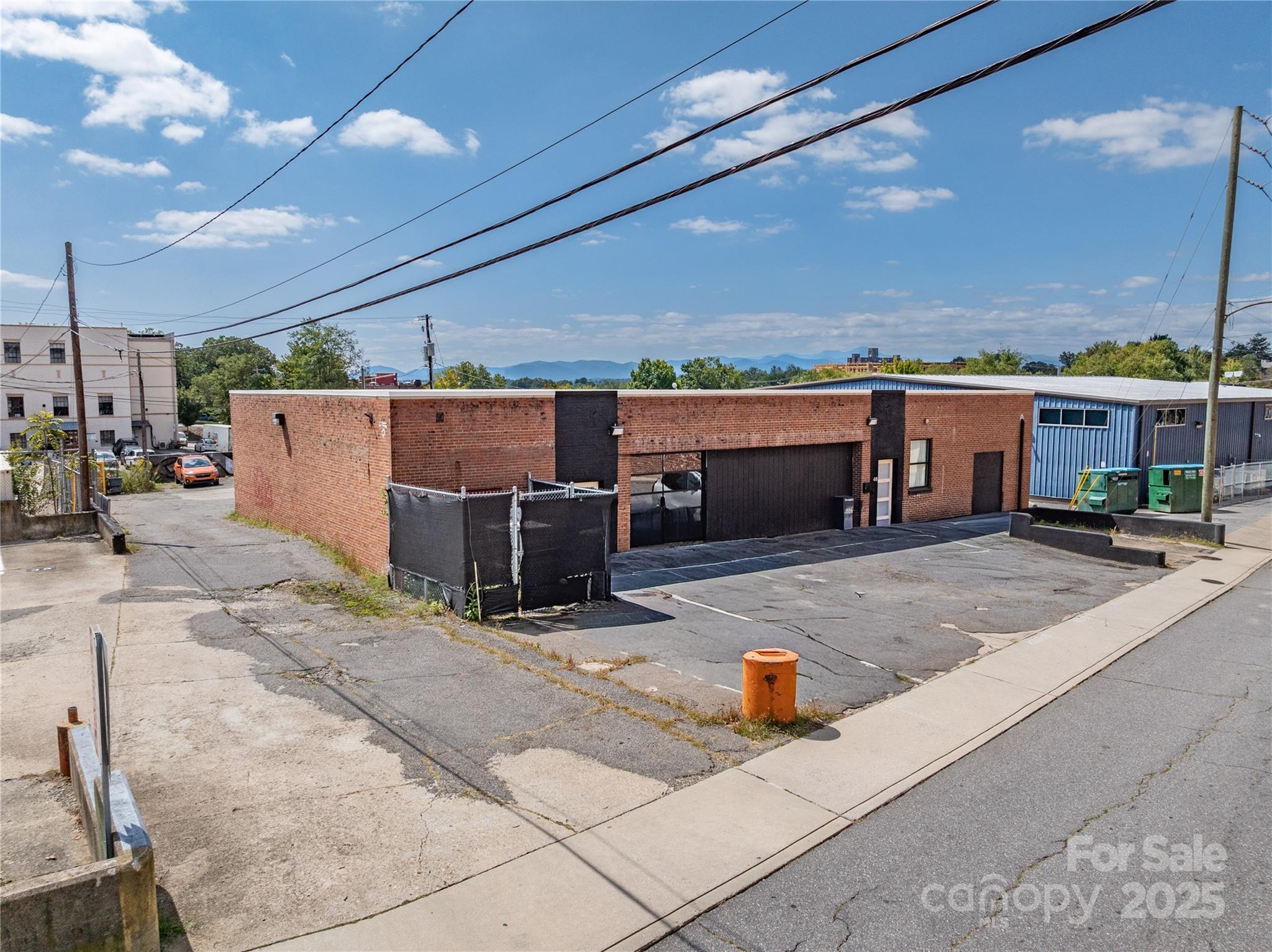 DPA is pleased to present this prime commercial property in Asheville’s Central Business District, ideal for owner-users and/or redevelopment. Offering exceptional flexibility, the 0.64 acre property includes a ±4,255 SF industrial loft/office building plus 2 lots containing 63 income producing parking spaces. The well-maintained building is equipped with central HVAC, loading dock, glass garage door, and multiple entrances. The adjacent lots have been approved by the City of Asheville for 231 micro-apartments. The property is within walking distance of Pack Square, Biltmore Avenue, and the South Slope.

Location Description
Pedestrian-friendly location in the Central Business District with an easy walk to downtown restaurants, hotels, breweries, and significant daytime employment population. From Patton Avenue in downtown Asheville, head south on Coxe Avenue, then left onto Aston Street. From Biltmore Avenue, head west on Aston Street.
