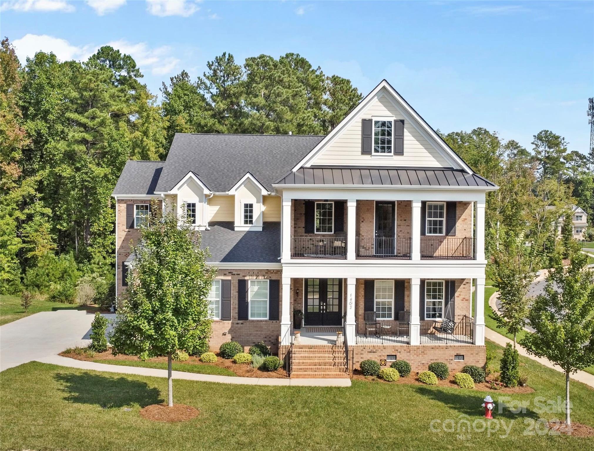 This like new home in The Falls at Weddington is everything you've been looking for and more. The main floor is equipped with 10' high ceilings, custom millwork throughout including not one but TWO full refrigerators and dishwashers and a beverage refrigerator. Enter through the double front door or from the garage to the mudroom and step into an open floor plan with an office, formal dining room and breakfast area that can fit a large dining table. The main level also includes a large guest bedroom with ensuite bathroom with a walk-in shower. The kitchen has a large island, pantry, and secondary kitchen area perfect for entertaining! Step outside through the massive sliding glass doors to the deck and enjoy the wooded back yard view. The primary suite feels just like having your own spa experience every day! Come see this amazing newer built home that checks all of your boxes!